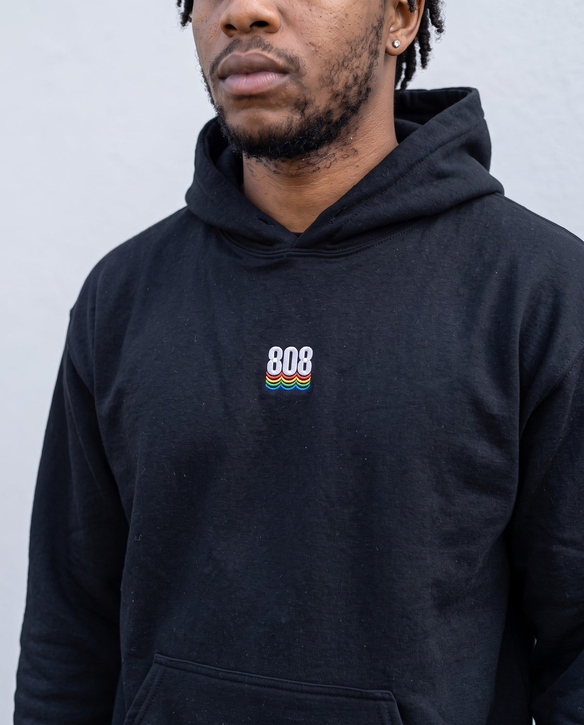 Model wearing the 808 hoodie in Black, print close-up