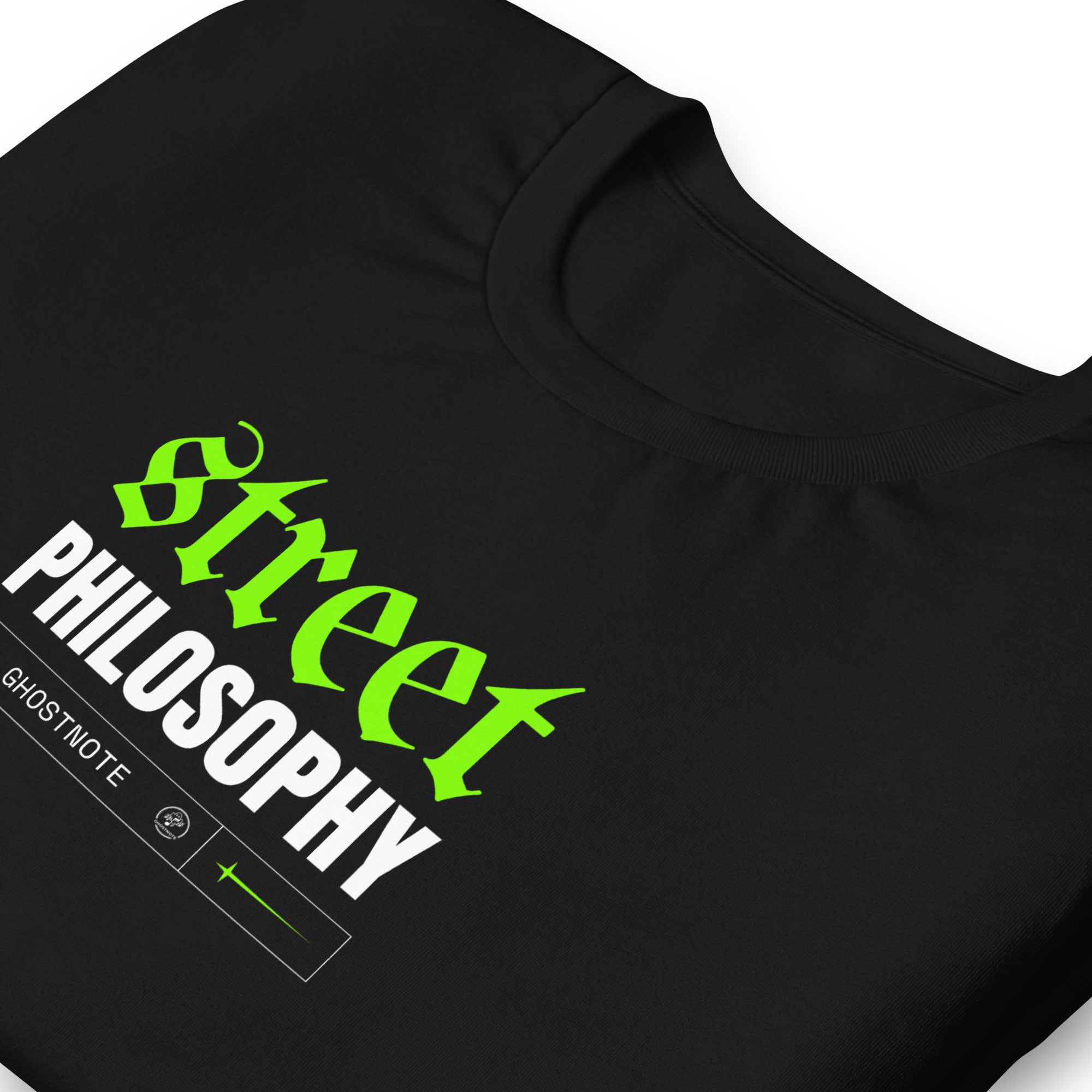 Black folded t-shirt with 'Street Philosophy' text in green and white on a black background with a streetwear style