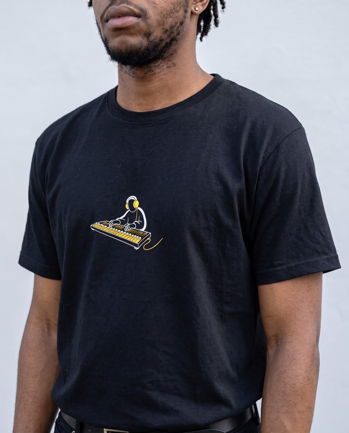 Model wearing the Behind The Board t-shirt in Black, print close-up