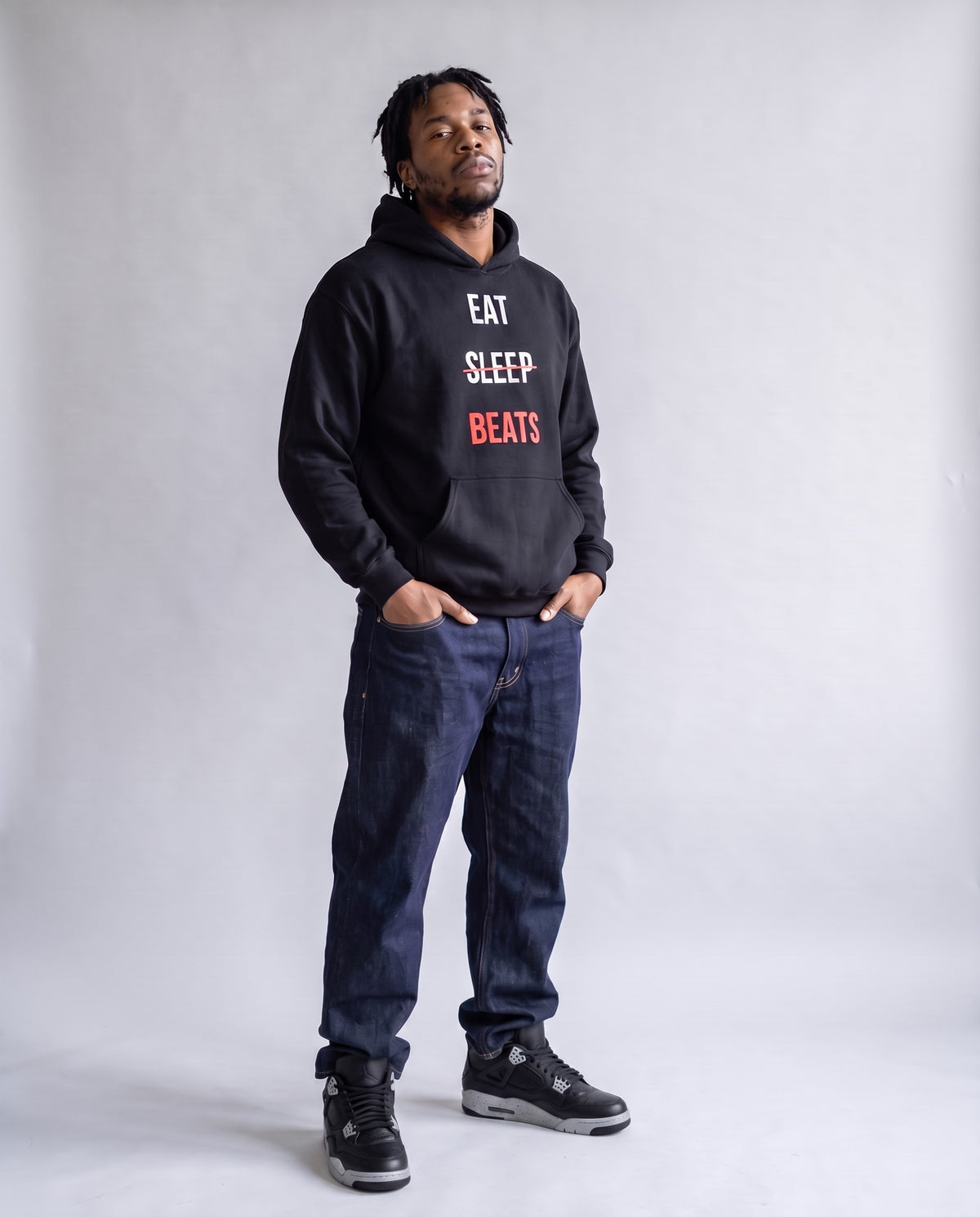 Model wearing the Eat Sleep Beats Producer Hoodie in Black, full length in jeans