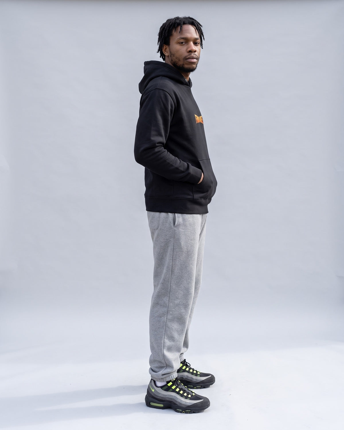 Model wearing the Firemaker Hoodie in Black, side profile