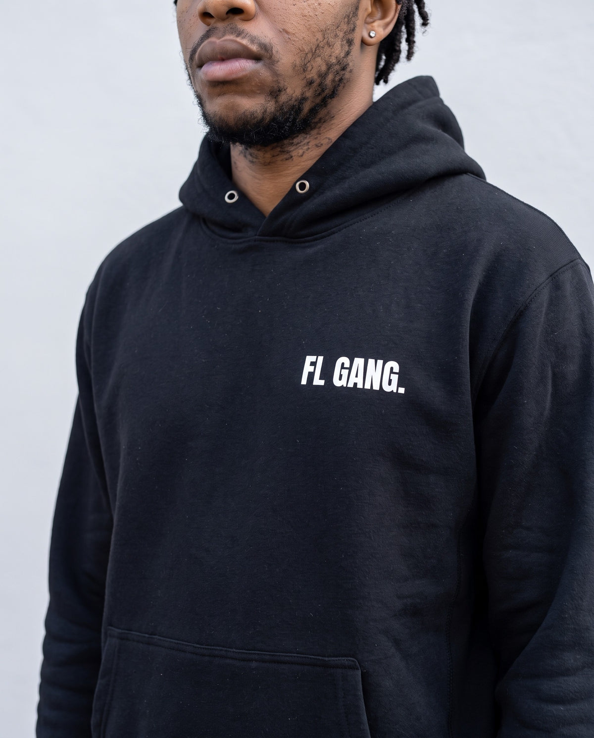 Model wearing the FL Gang Premium Hoodie in Black, print close-up