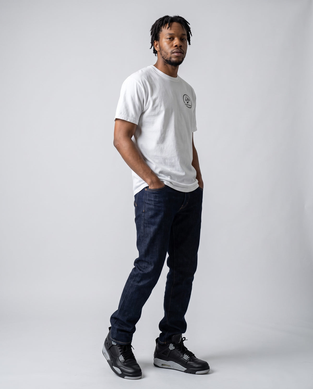 Model wearing the Ghostnote Premium Heavyweight Tee (Light Colors) in White, full length
