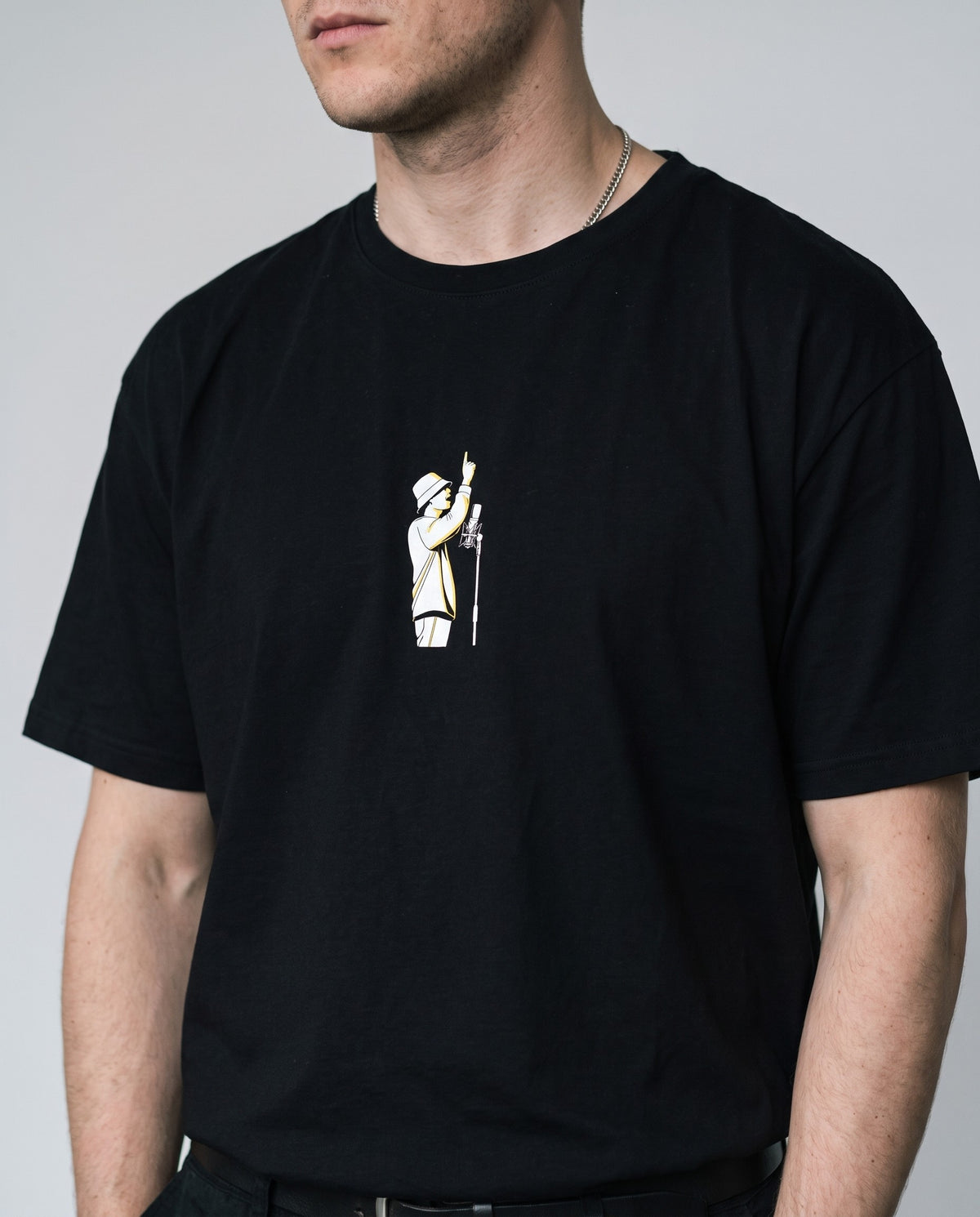 Model wearing the Hands Up t-shirt in Black, print close-up