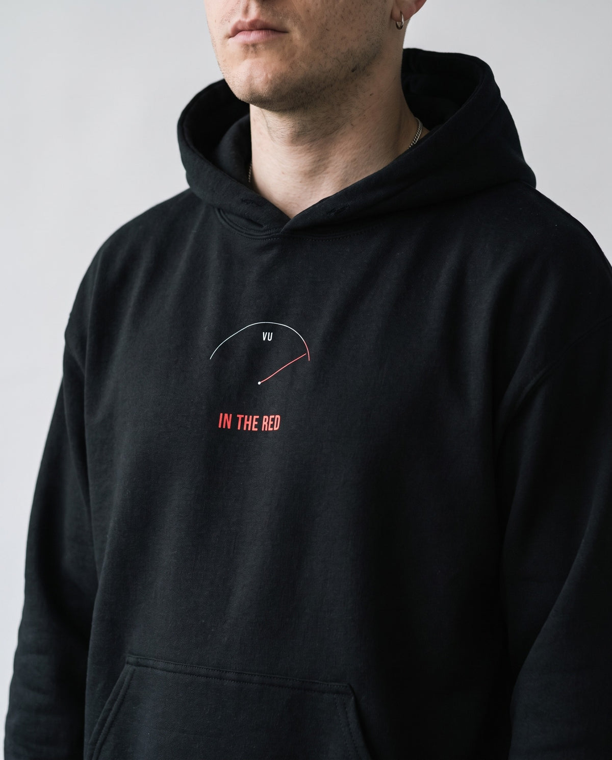 Model wearing the In The Red hoodie in Black, print close-up