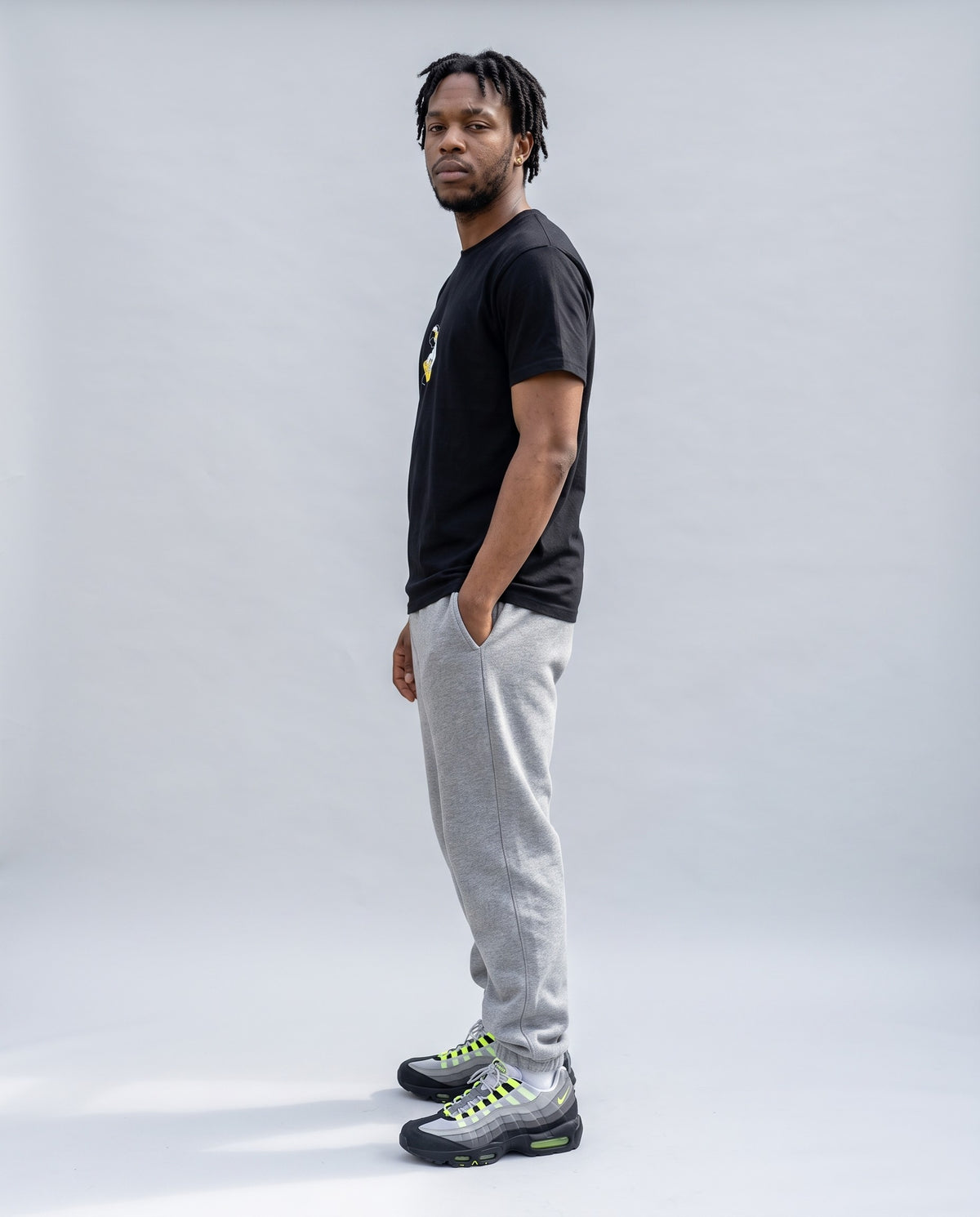 Model wearing the MPC Fingers t-shirt in Black, side profile