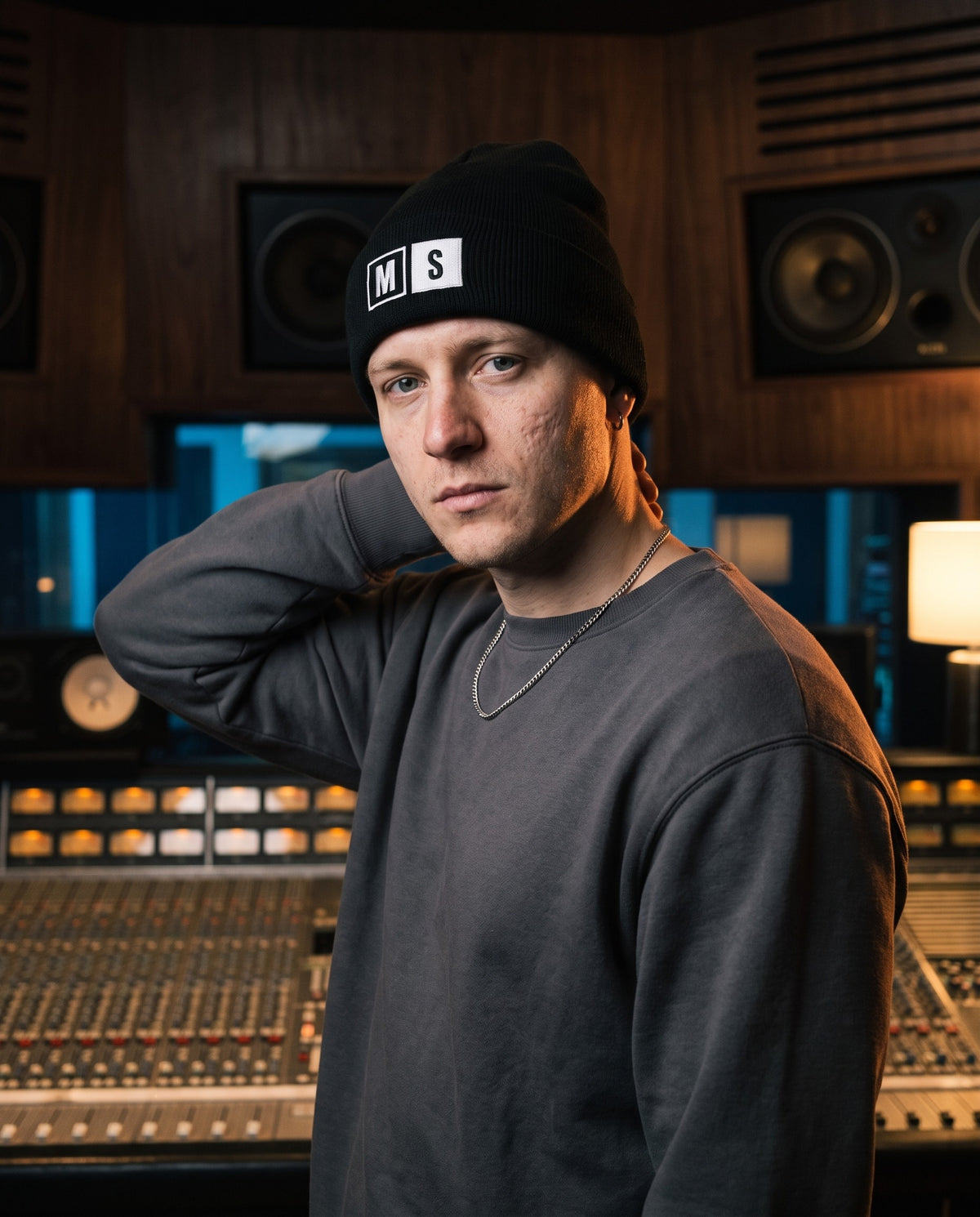 Model wearing the Mute / Solo beanie in Black in a recording studio control room