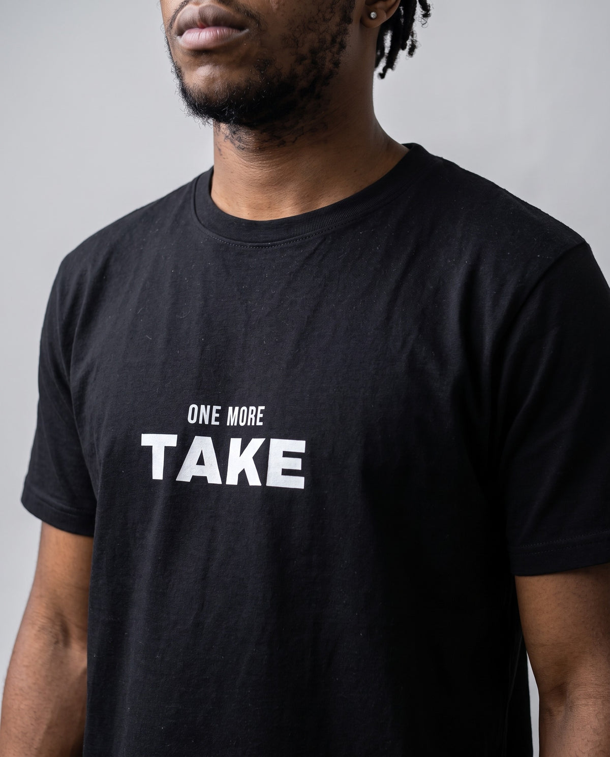 Model wearing the One More Take t-shirt in Black, print close-up