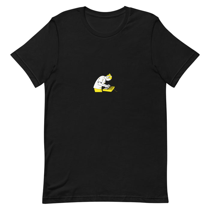 Black t-shirt with a white-and-yellow illustration of a producer on an MPC drum machine — Ghostnote music producer tee, flat front