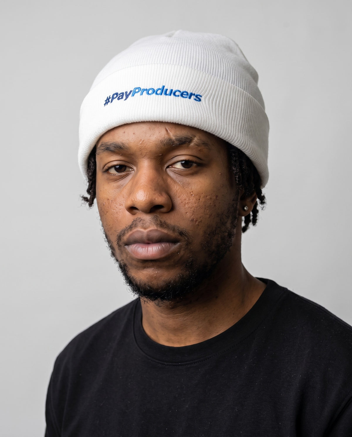 Model wearing the Pay Producers Beanie in White
