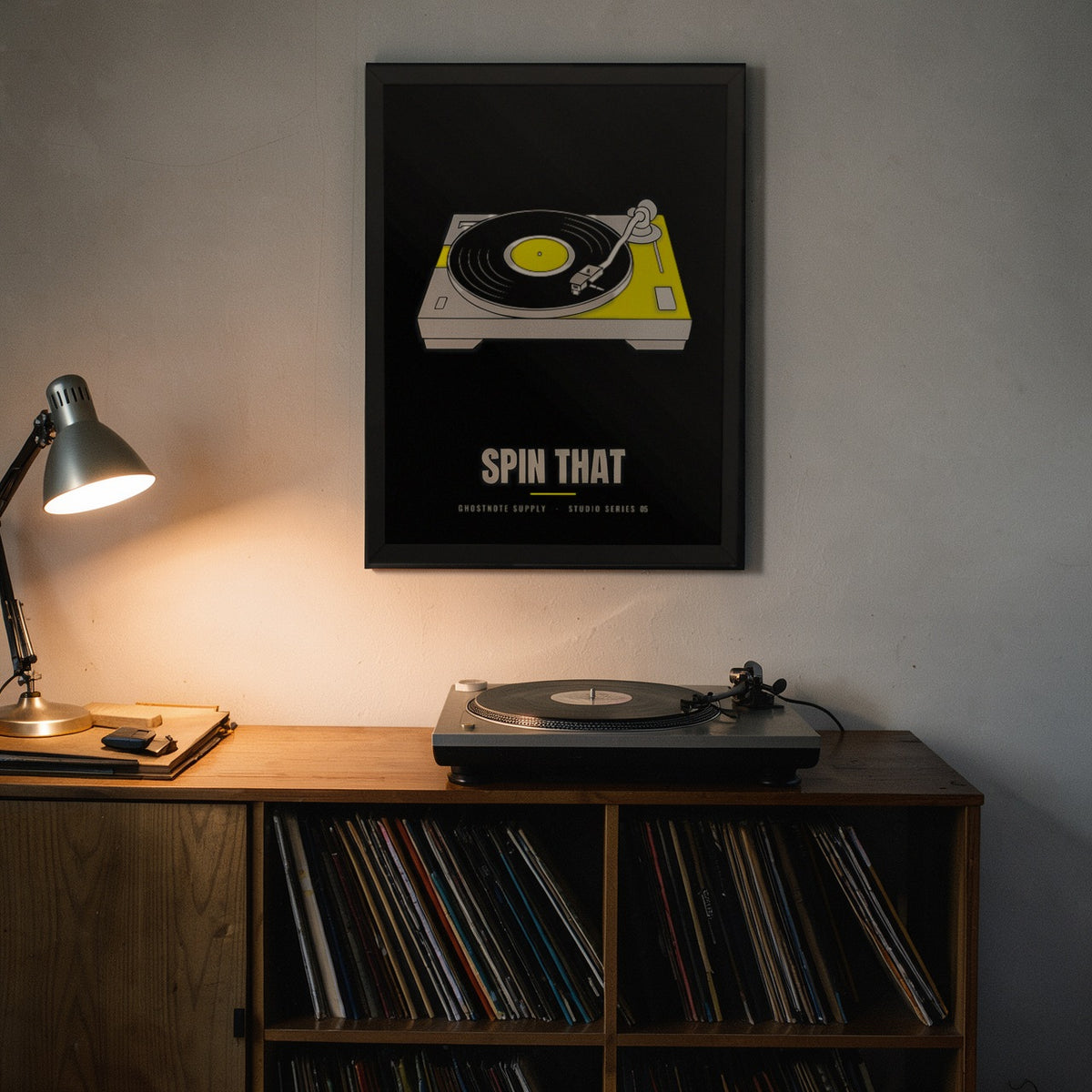 Spin That Studio Poster framed on a home studio wall above a turntable and record shelf
