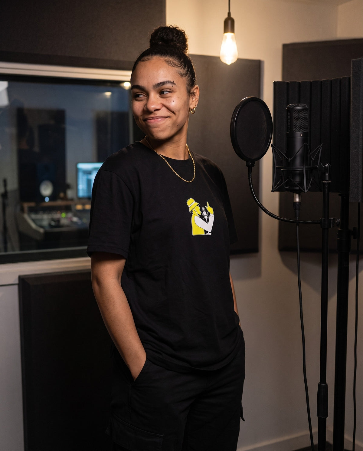 Model wearing the Spit Fire t-shirt in Black, in a vocal booth