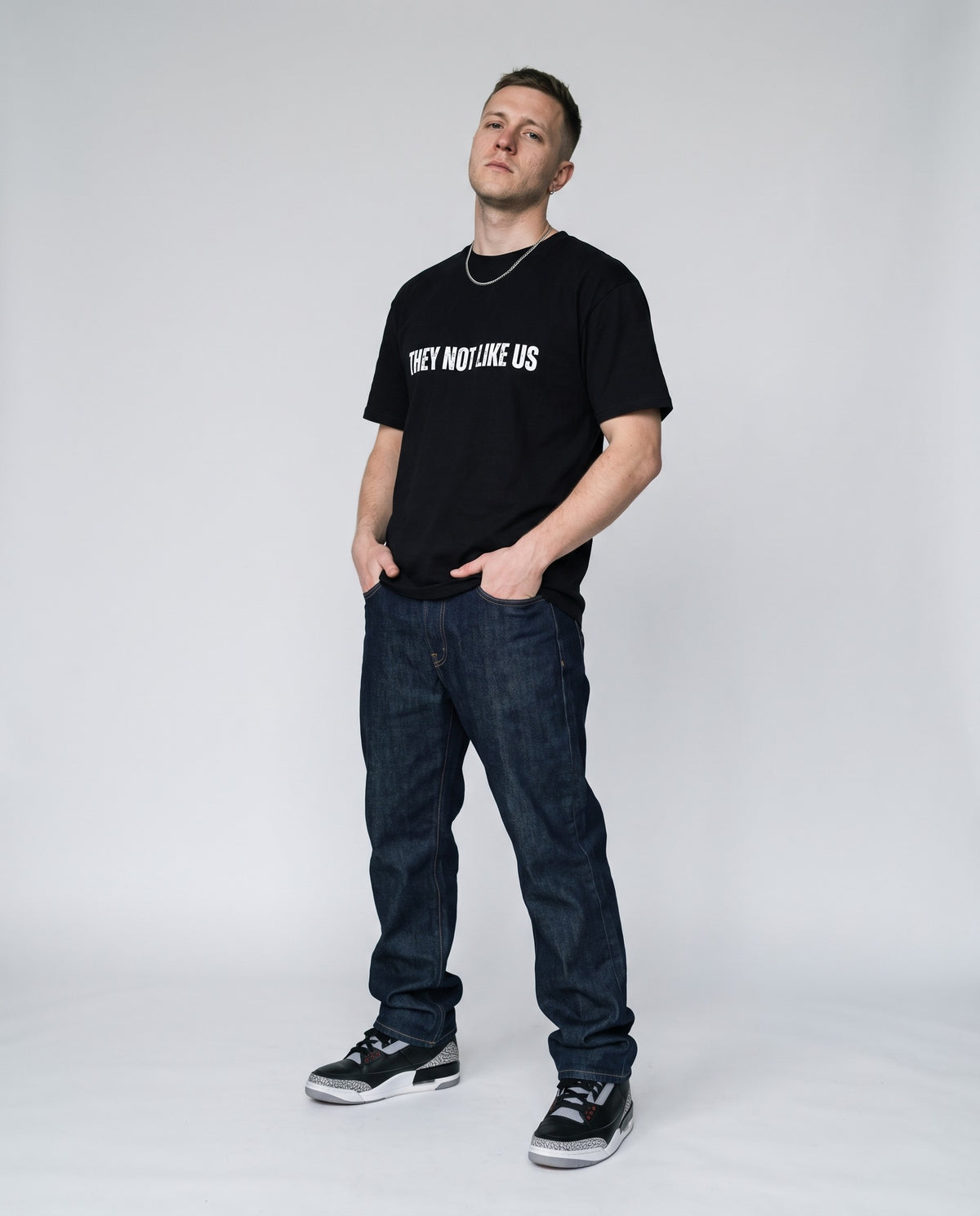 Model wearing the They Not Like Us t-shirt in Black, full length