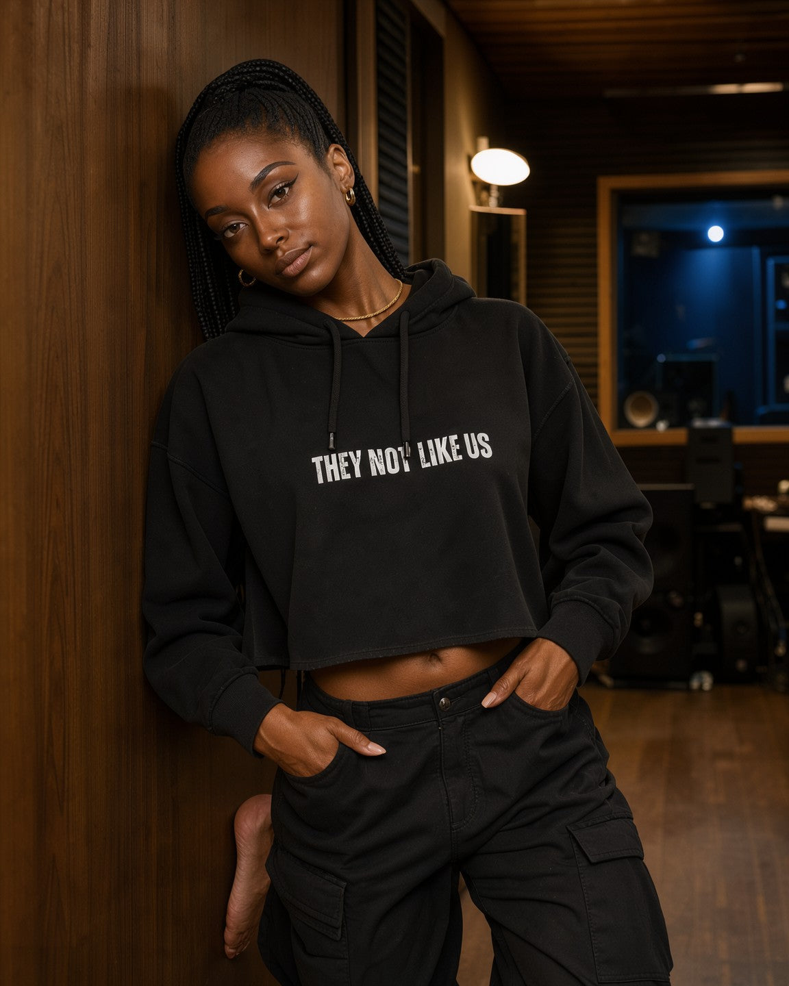 Model wearing the They Not Like Us Women's Cropped Hoodie in Black