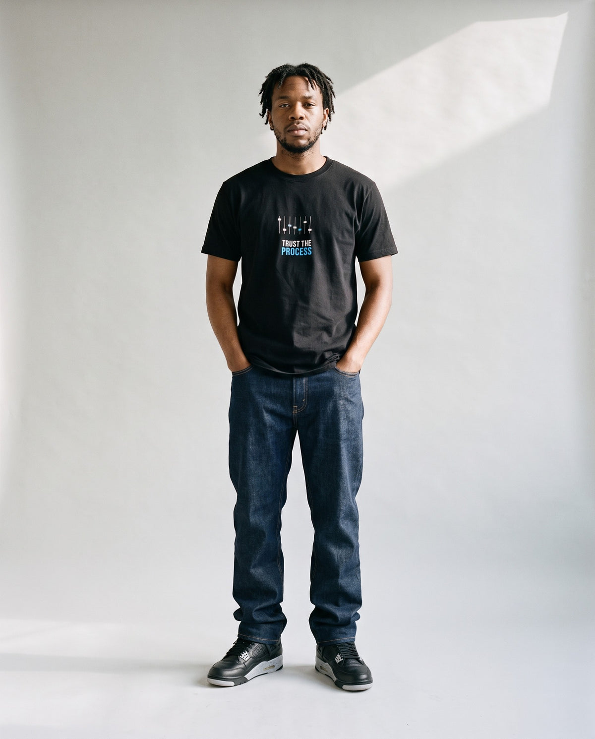 Model wearing the Trust The Process t-shirt in Black, full length