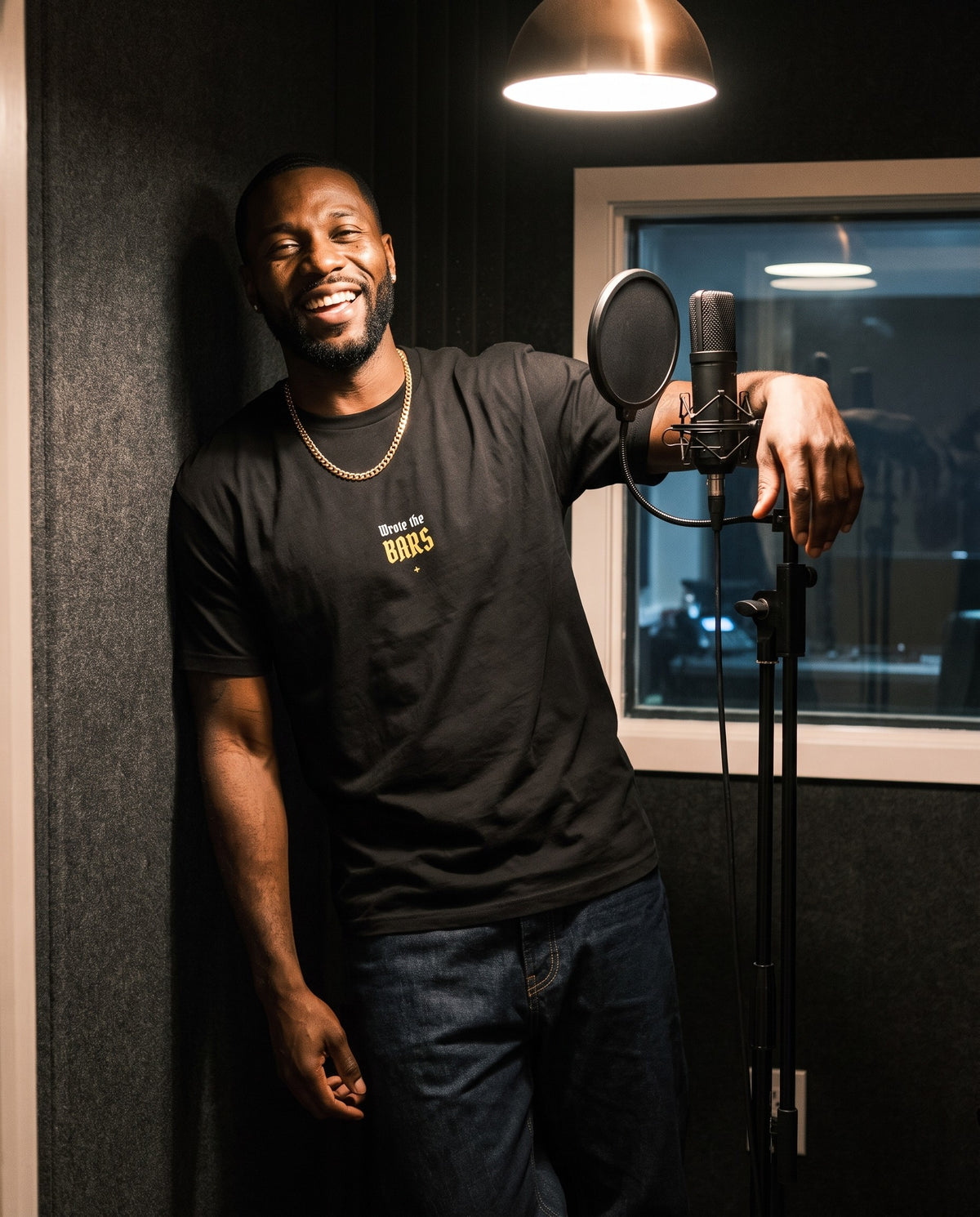Model wearing the Wrote The Bars t-shirt in Black, in a vocal booth