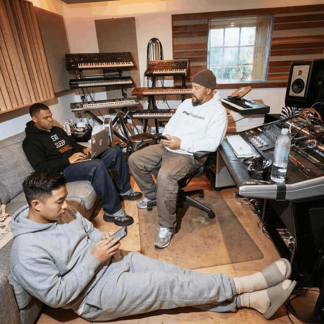 Music producers in hoodies vibing together in the studio
