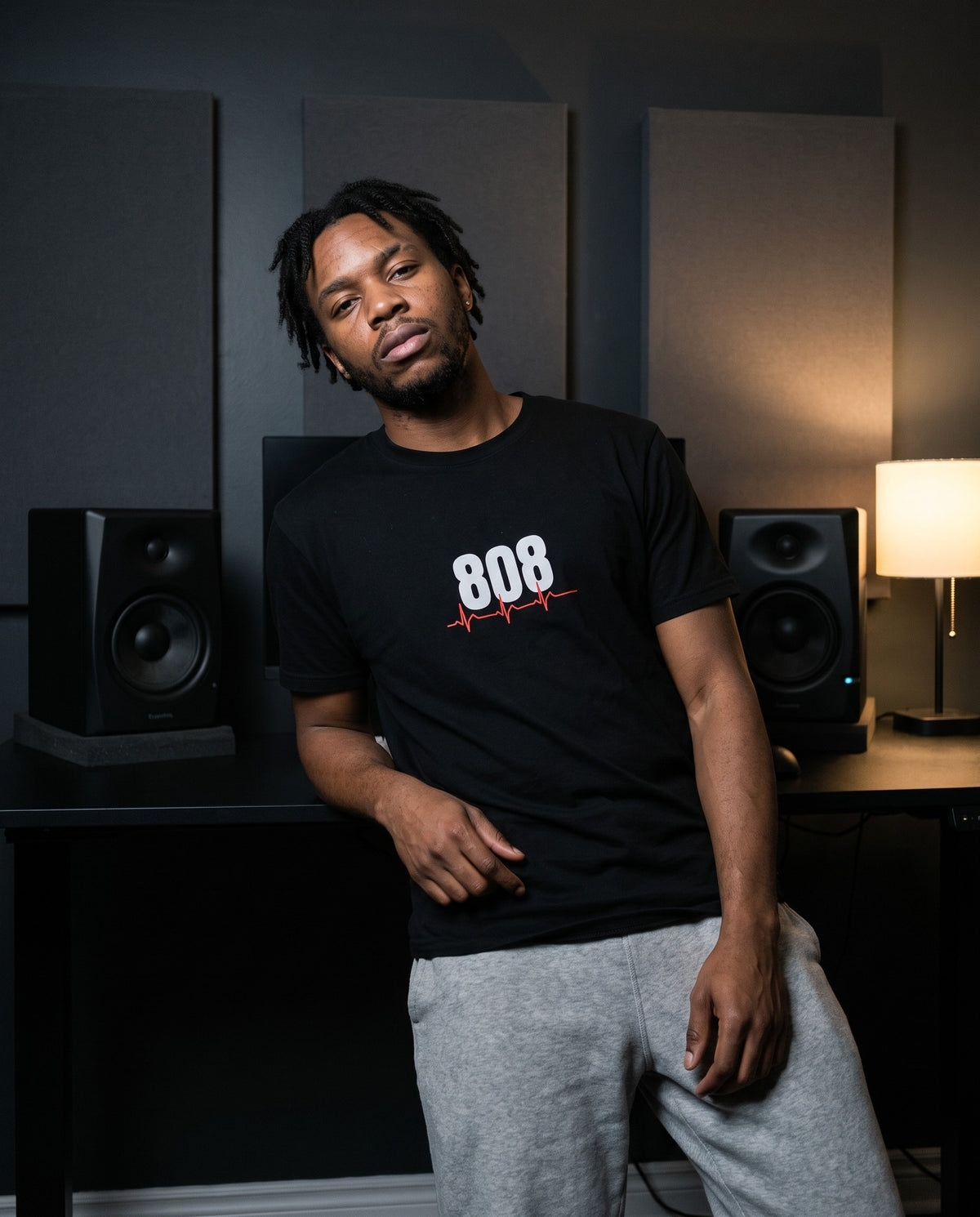 Model wearing the 808 Is My Heartbeat t-shirt in Black, in a home studio