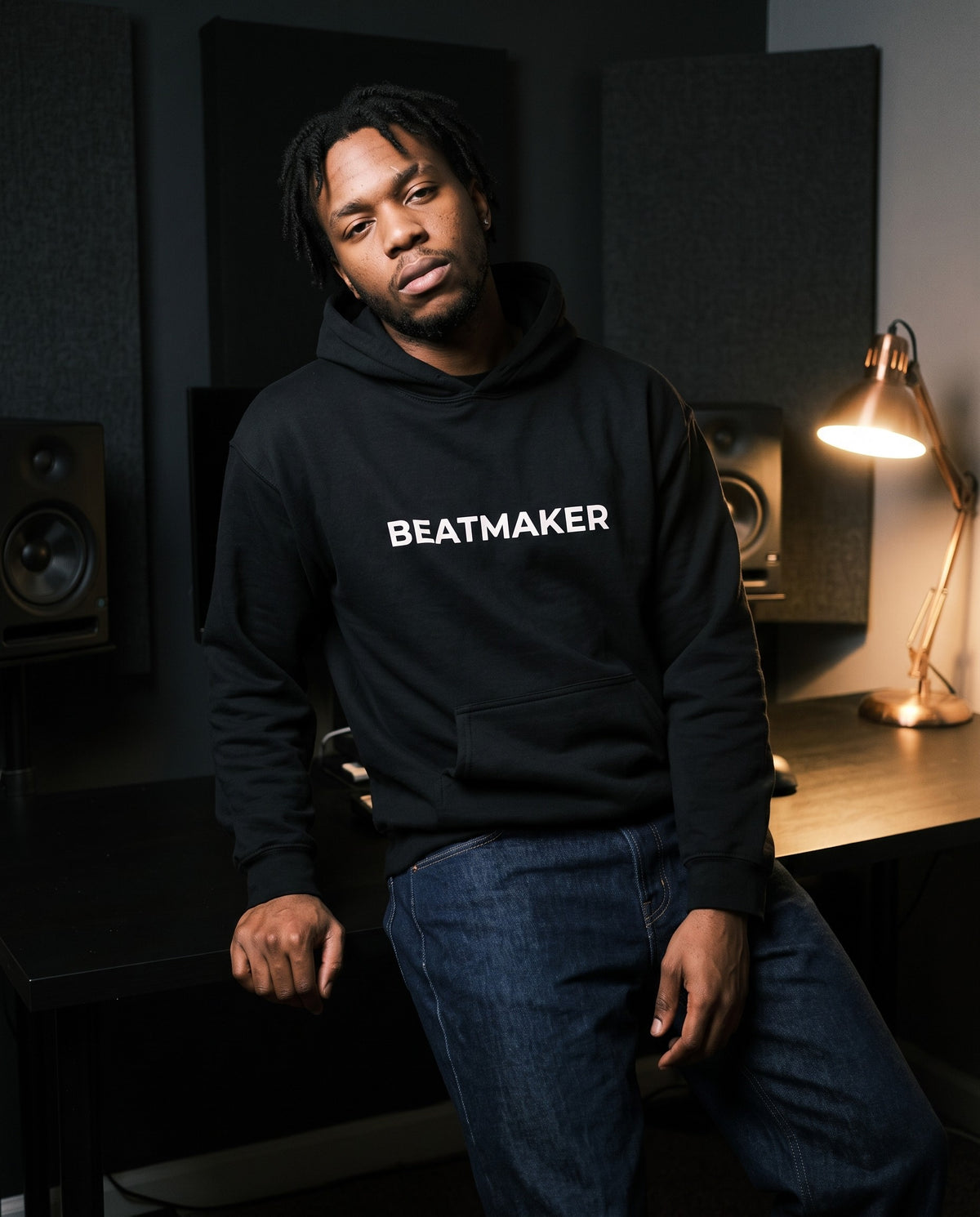 Model wearing the Beatmaker Hoodie in Black, in a home studio