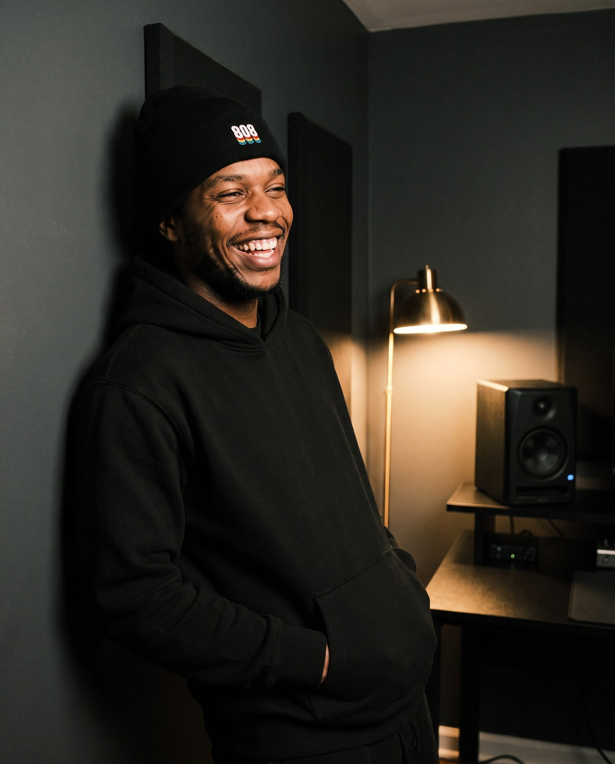 Model wearing the 808 Sound Black Beanie in Black, in a home studio