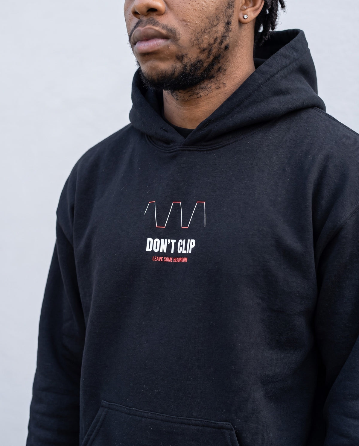 Model wearing the Don't Clip hoodie in Black, print close-up