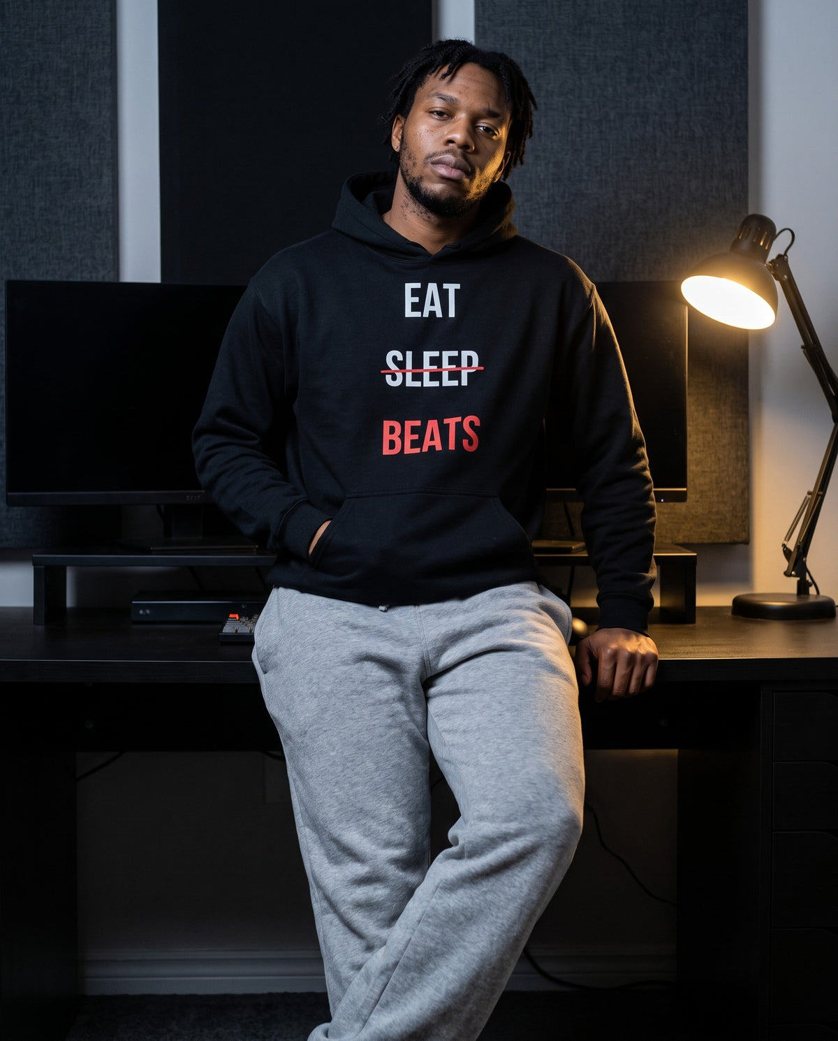 Model wearing the Eat Sleep Beats Producer Hoodie in Black, in a home studio