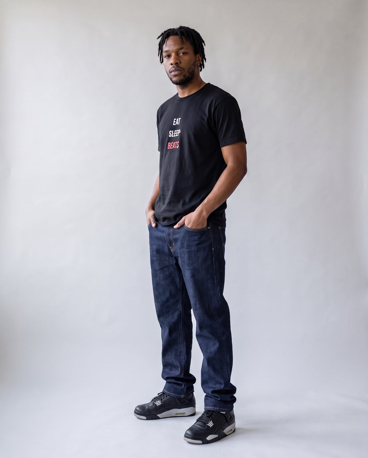 Model wearing the Eat Sleep Beats t-shirt in Black, full length