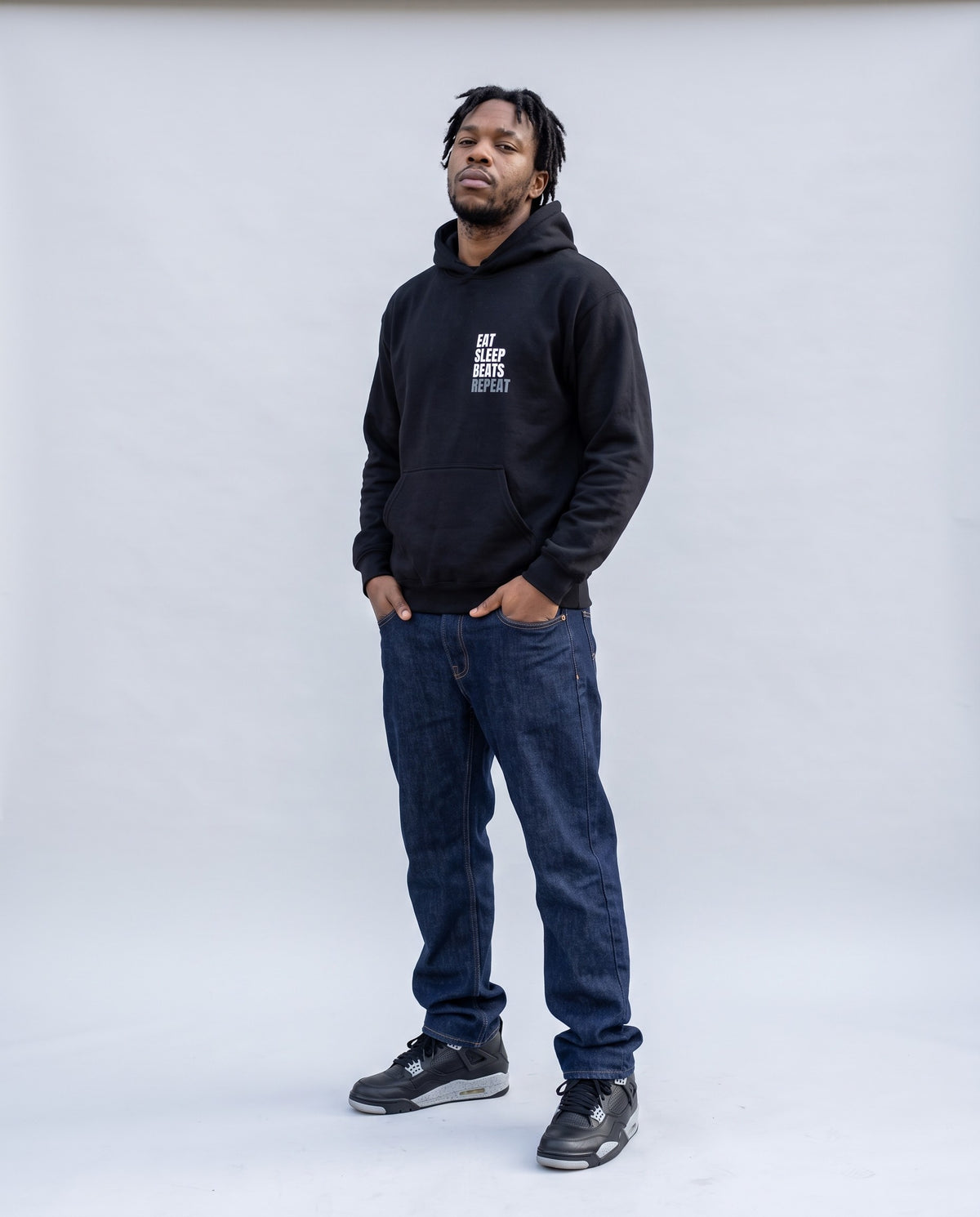 Model wearing the Eat Sleep Beats Repeat hoodie in Black, full length