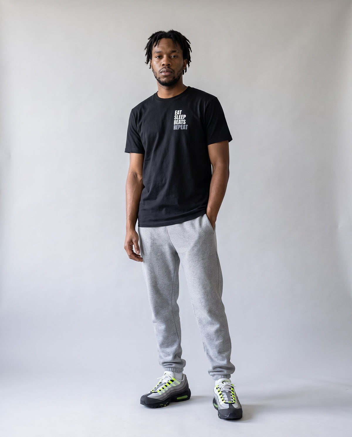 Model wearing the Eat Sleep Beats Repeat t-shirt in Black, full length