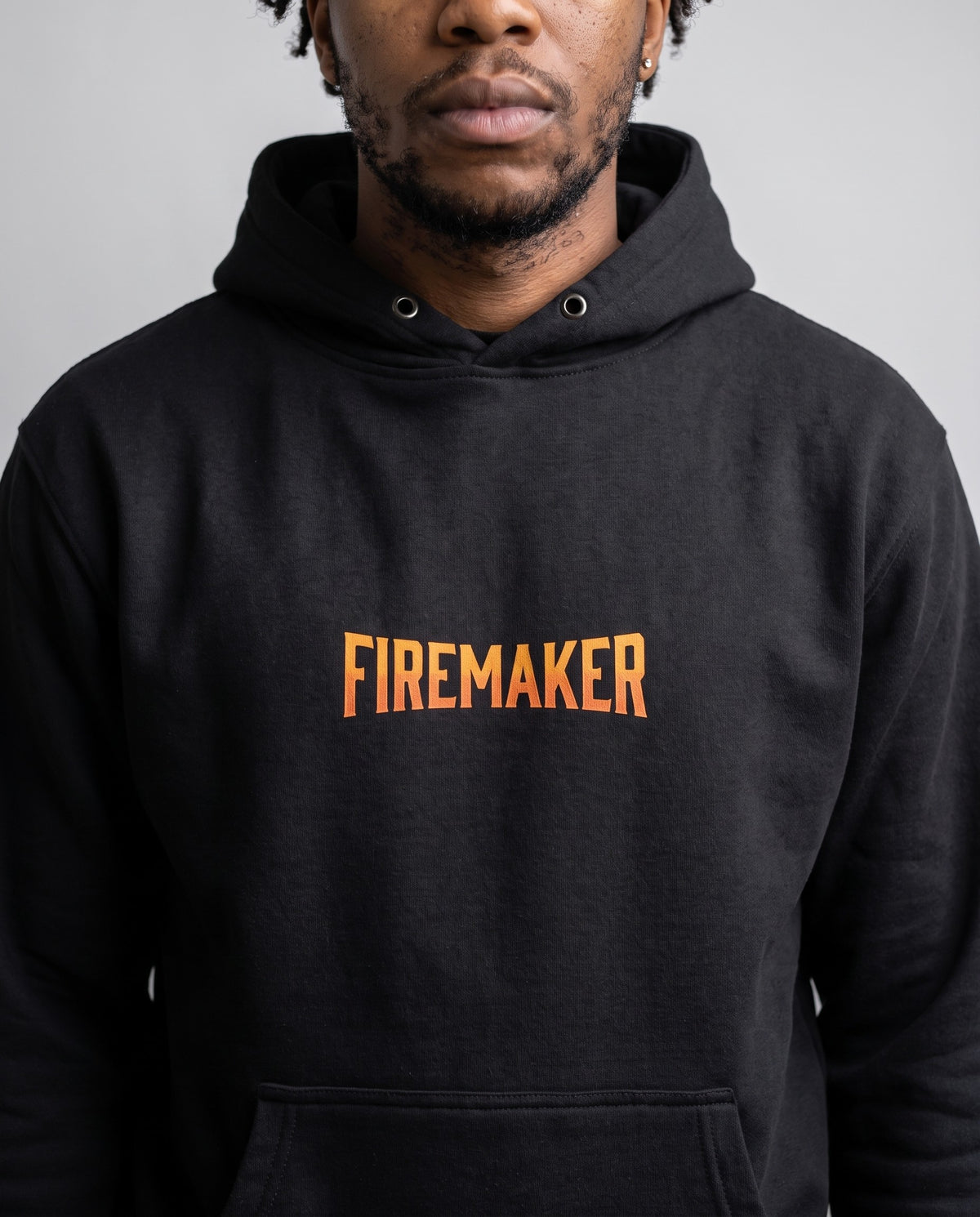 Model wearing the Firemaker Hoodie in Black, print close-up
