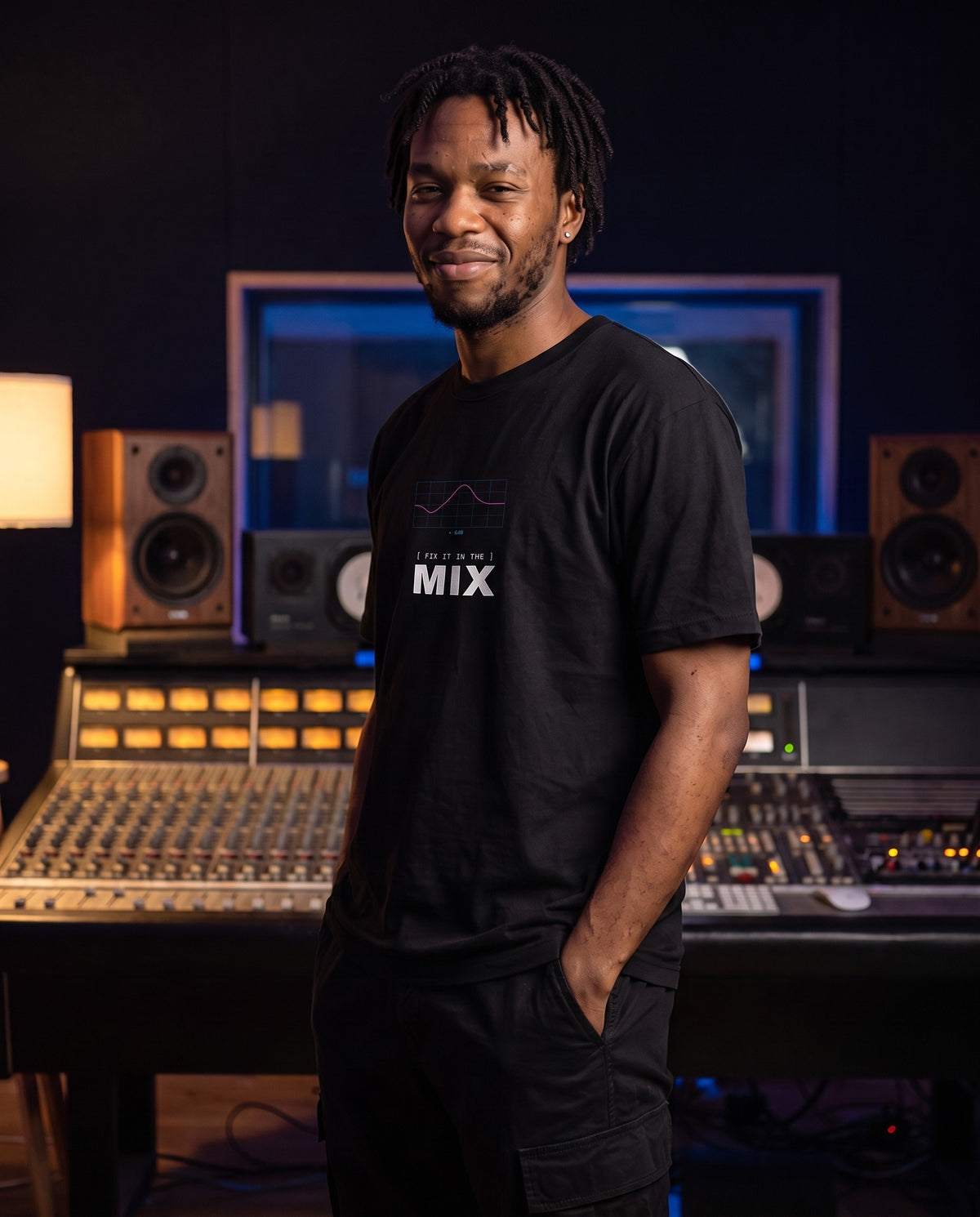 Model wearing the Fix It In The Mix t-shirt in Black, in a recording studio control room