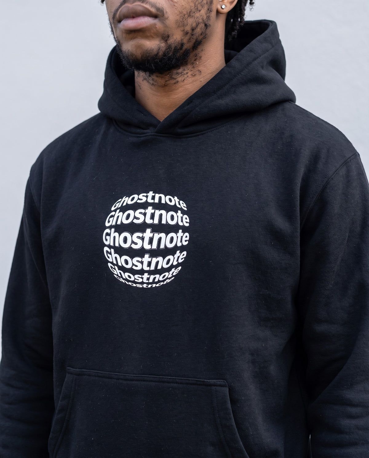 Model wearing the Ghostnote Alternative hoodie in Black, print close-up