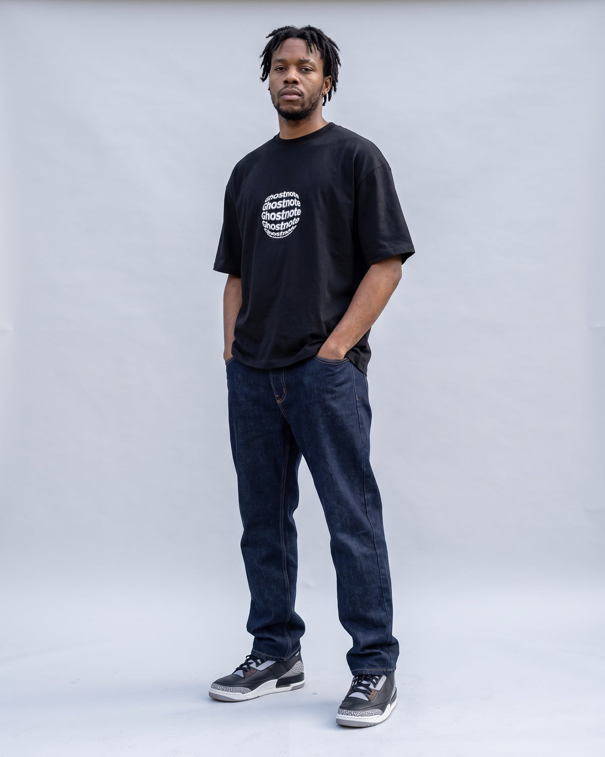 Model wearing the Ghostnote Premium OVERSIZED T-Shirt in Black, full length