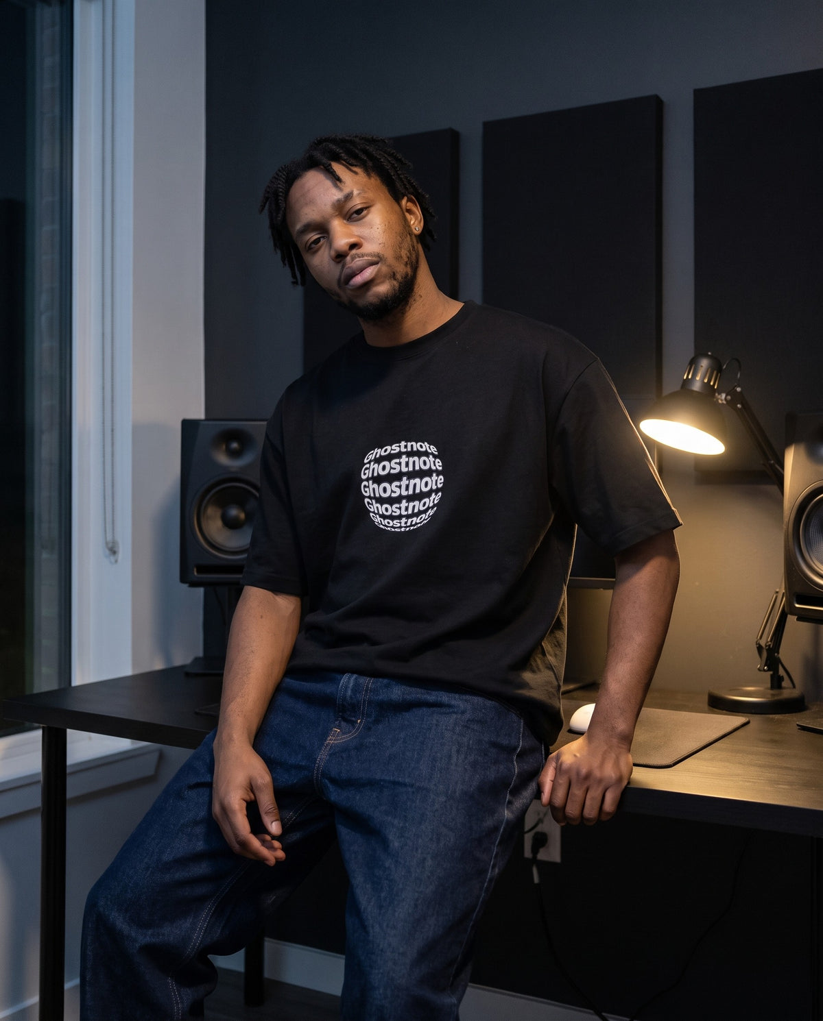 Model wearing the Ghostnote Premium OVERSIZED T-Shirt in Black, in a home studio