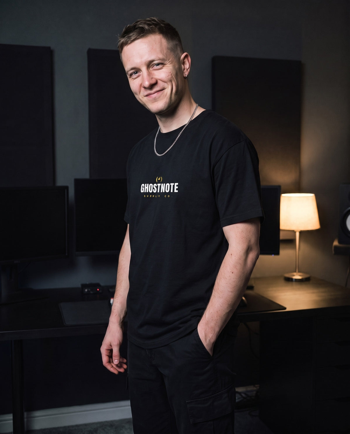 Model wearing the Ghostnote Wordmark t-shirt in Black, in a home studio