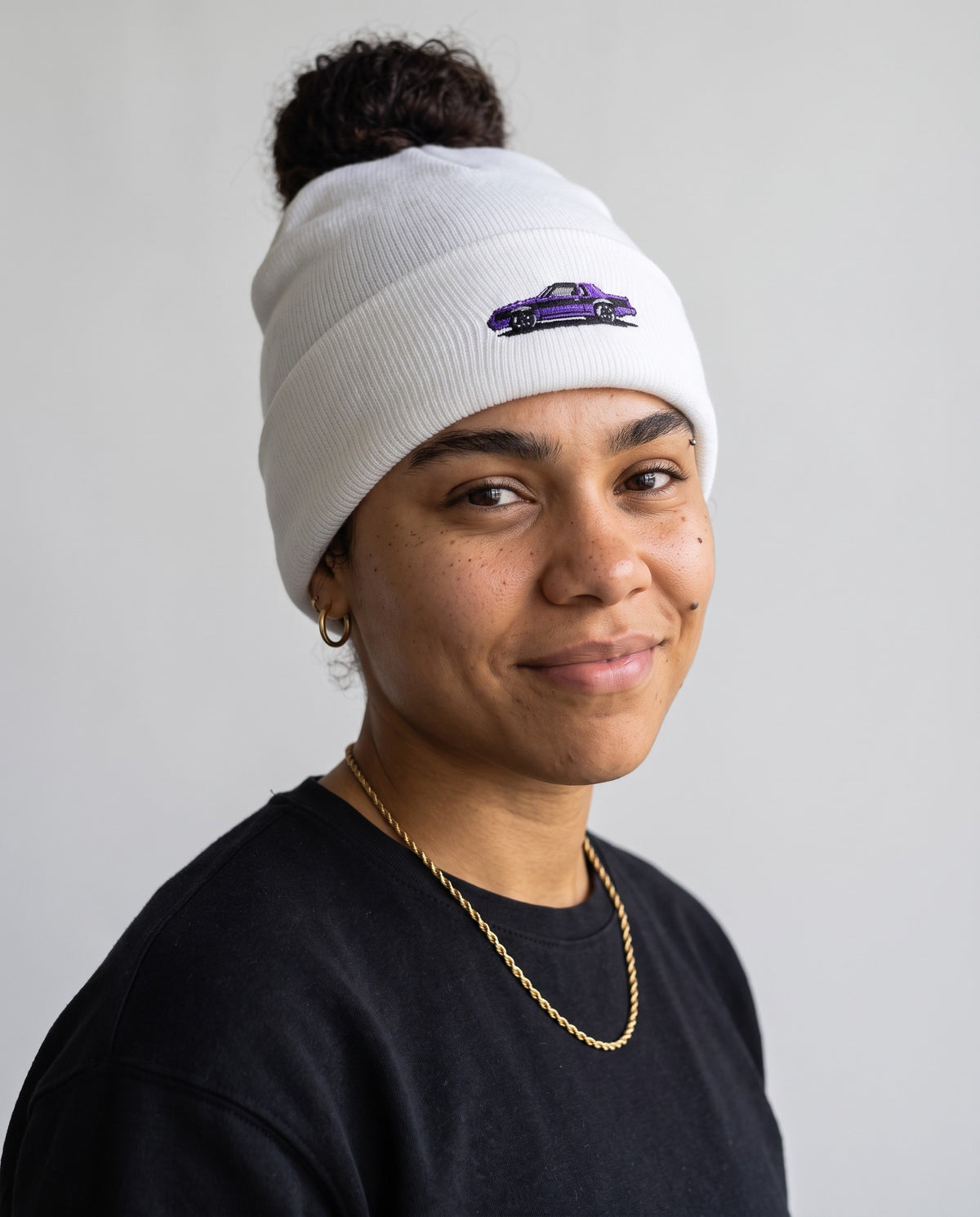 Model wearing the GNX Inspired Beanie in White, head and shoulders