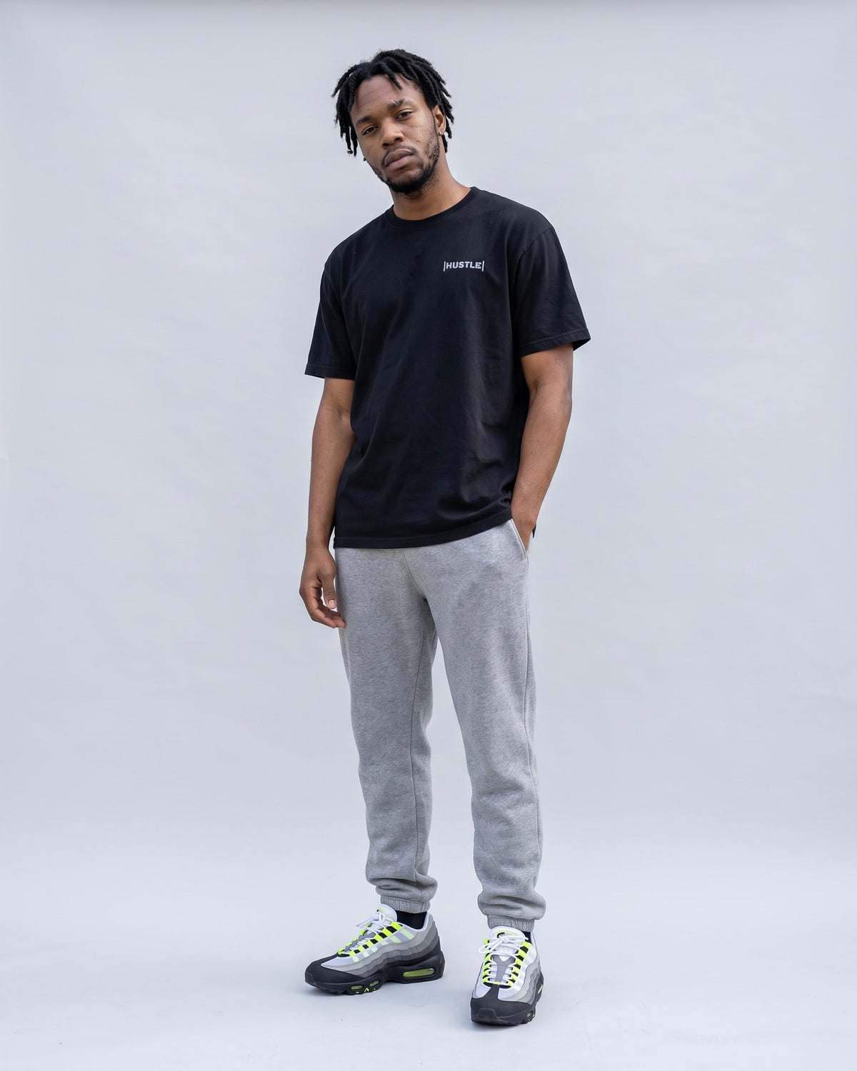Model wearing the Hustle t-shirt in Black, full length