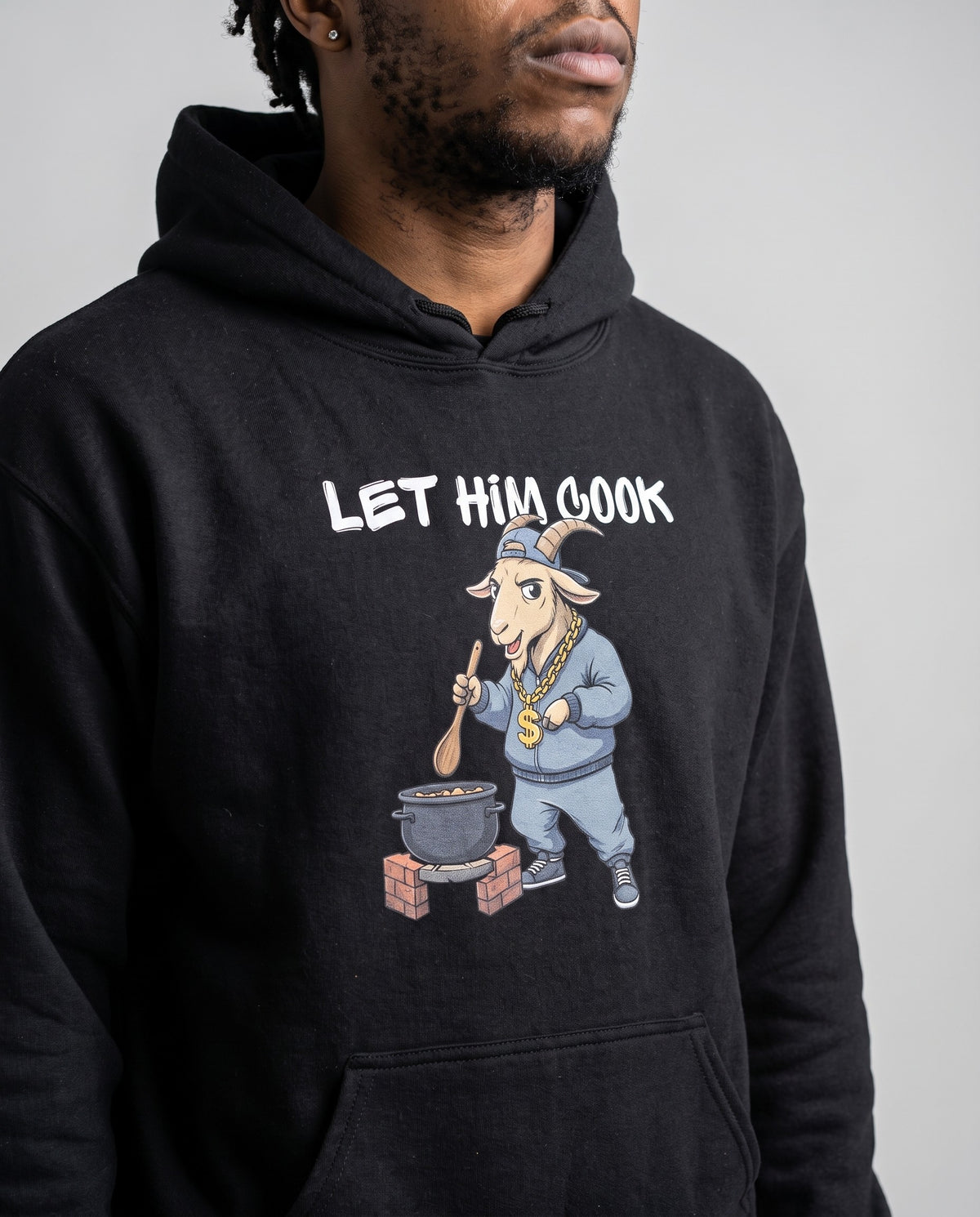 Model wearing the Let Him Cook hoodie in Black, print close-up
