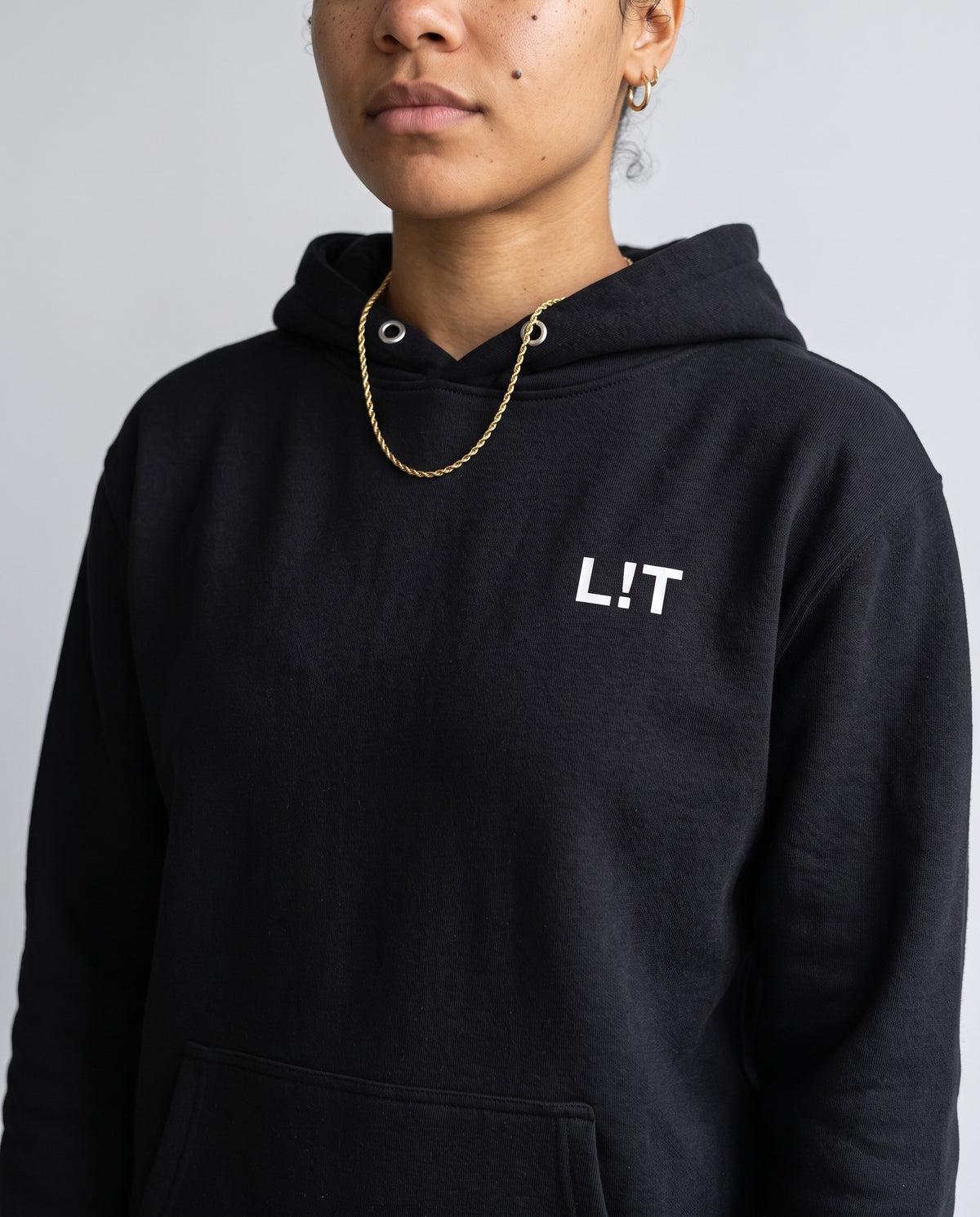 Model wearing the L!T Hoodie in Black, print close-up