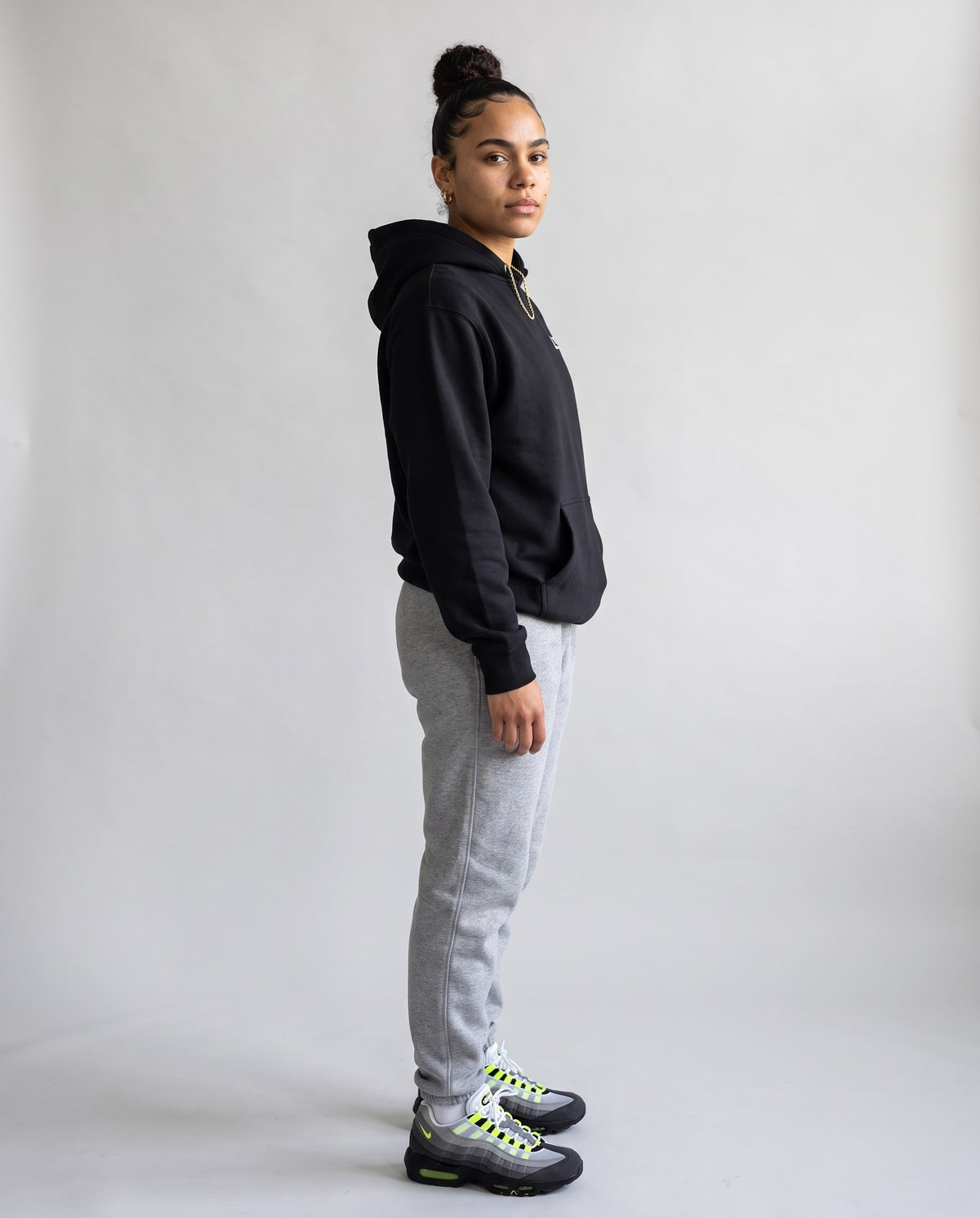 Model wearing the L!T Hoodie in Black, side profile