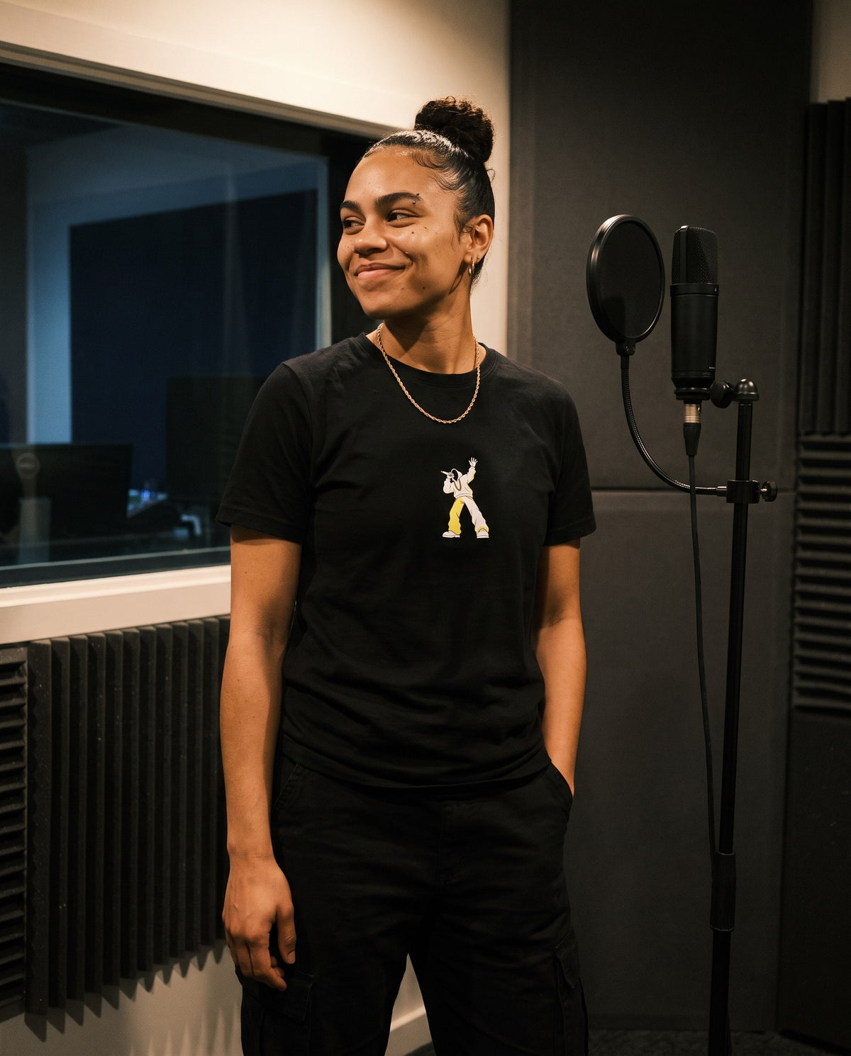 Model wearing the Move The Crowd t-shirt in Black, in a vocal booth