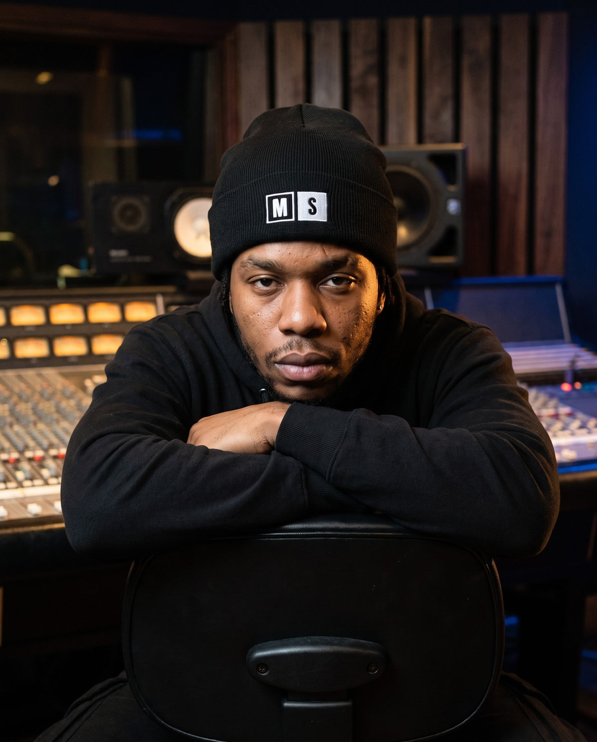 Model wearing the Mute / Solo beanie in Black in a recording studio control room