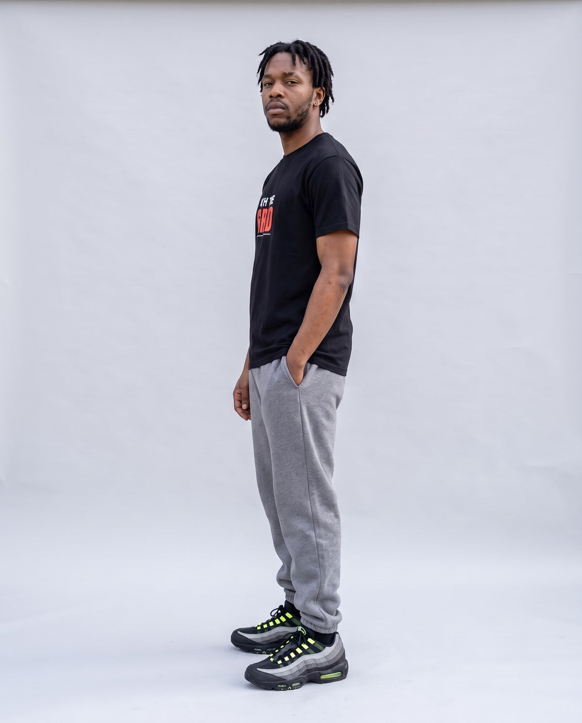 Model wearing the Off The Grid t-shirt in Black, side profile