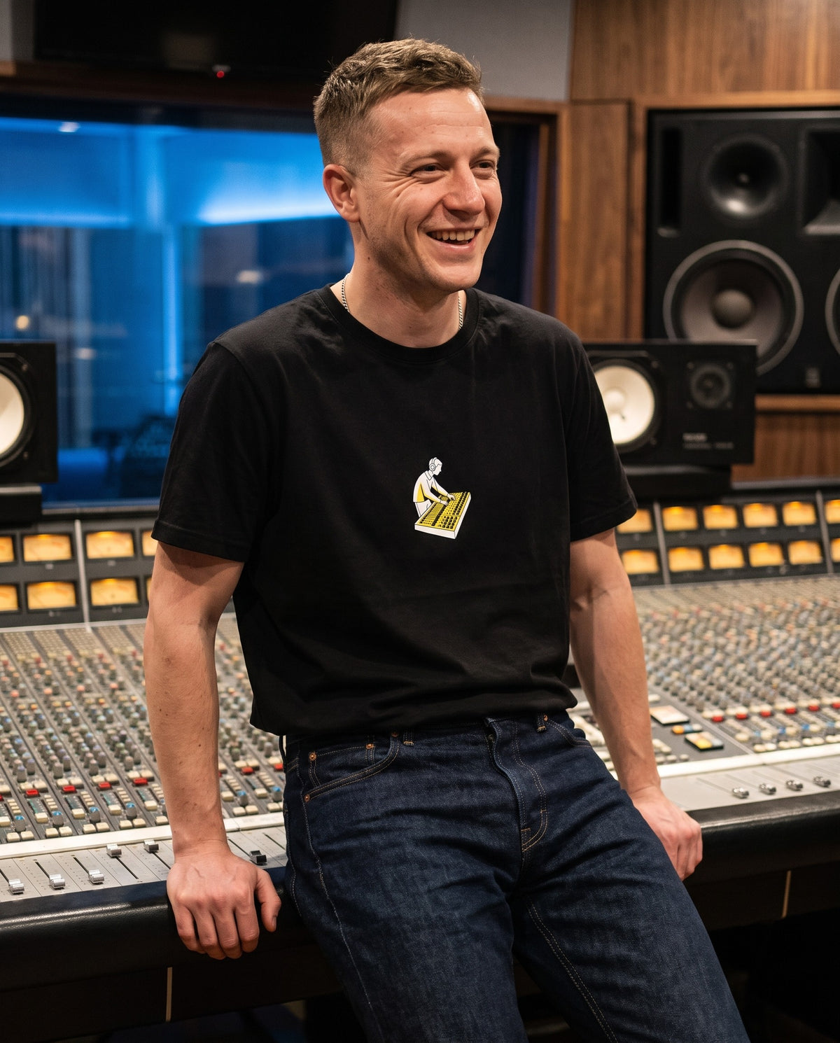 Model wearing the On The Console t-shirt in Black, in a recording studio control room