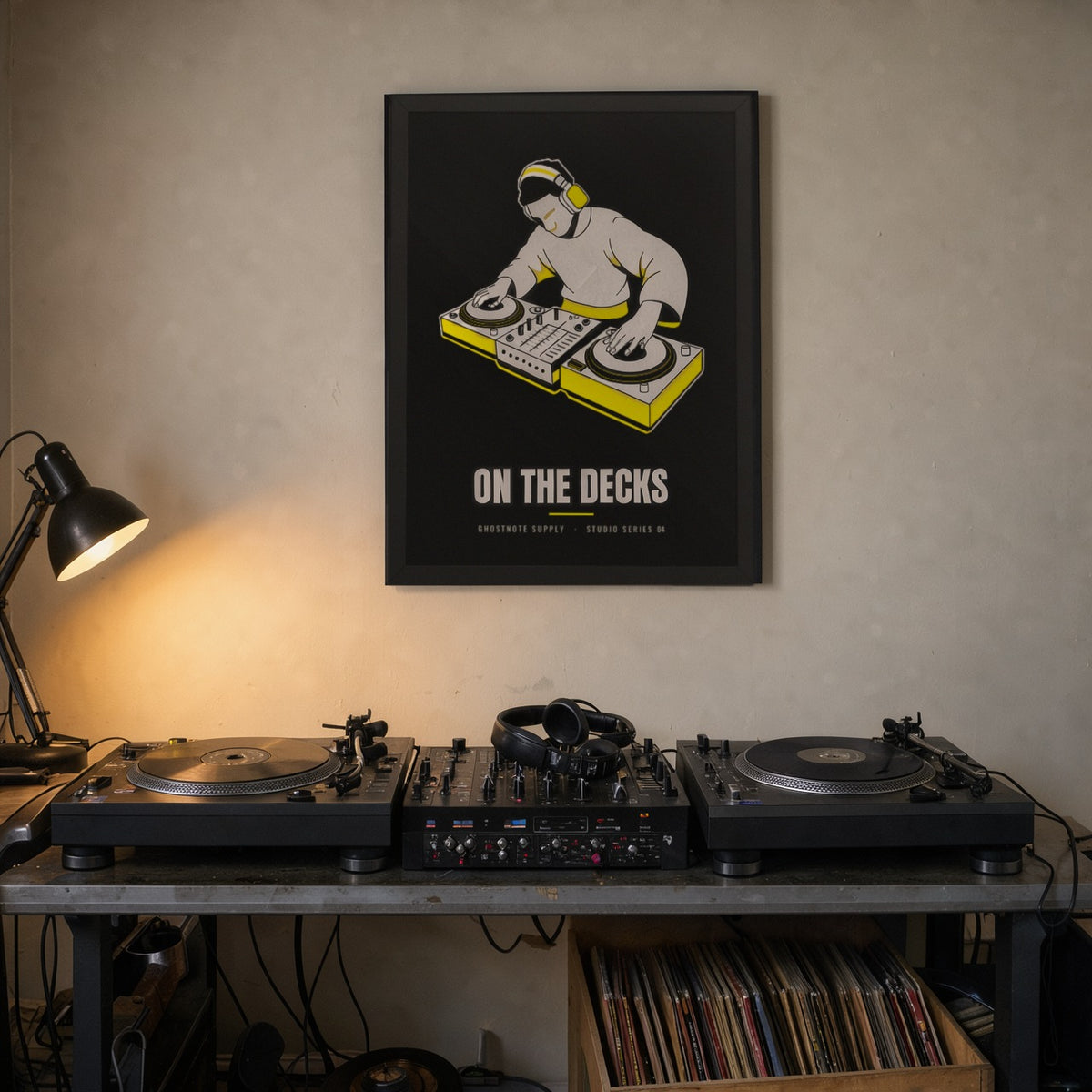 On The Decks Studio Poster framed on a home studio wall above a DJ setup