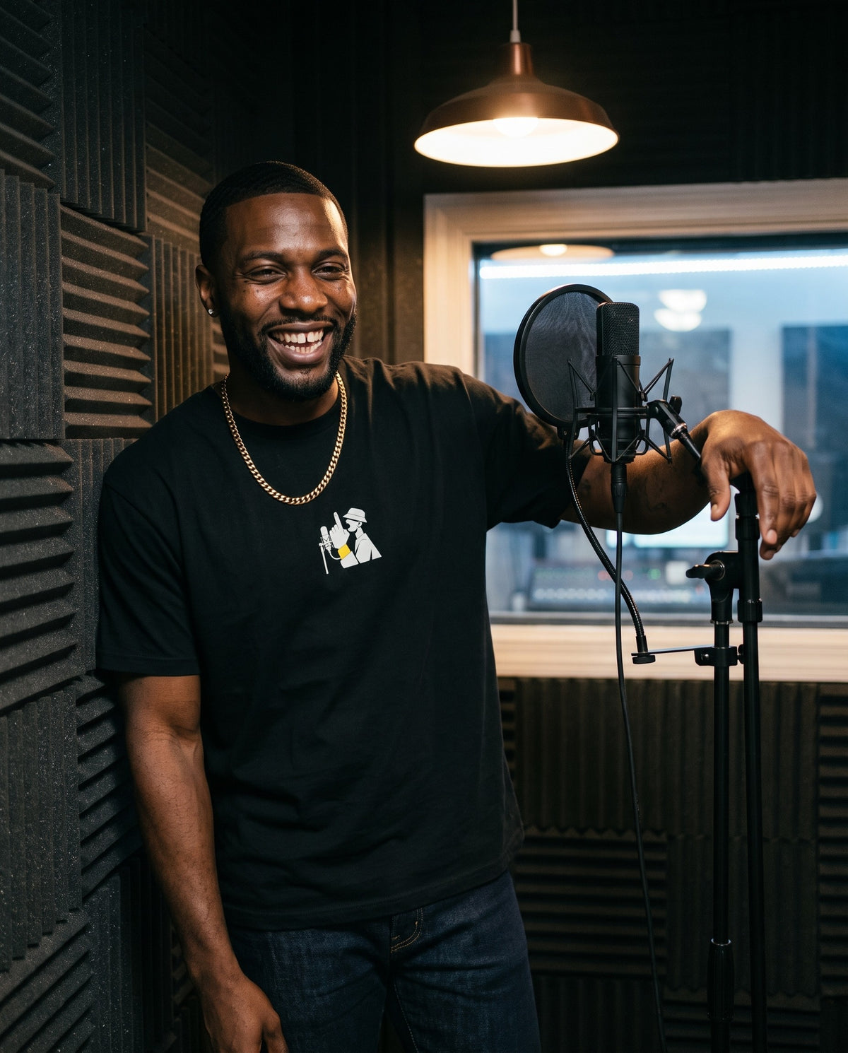 Model wearing the On The Mic t-shirt in Black, in a vocal booth