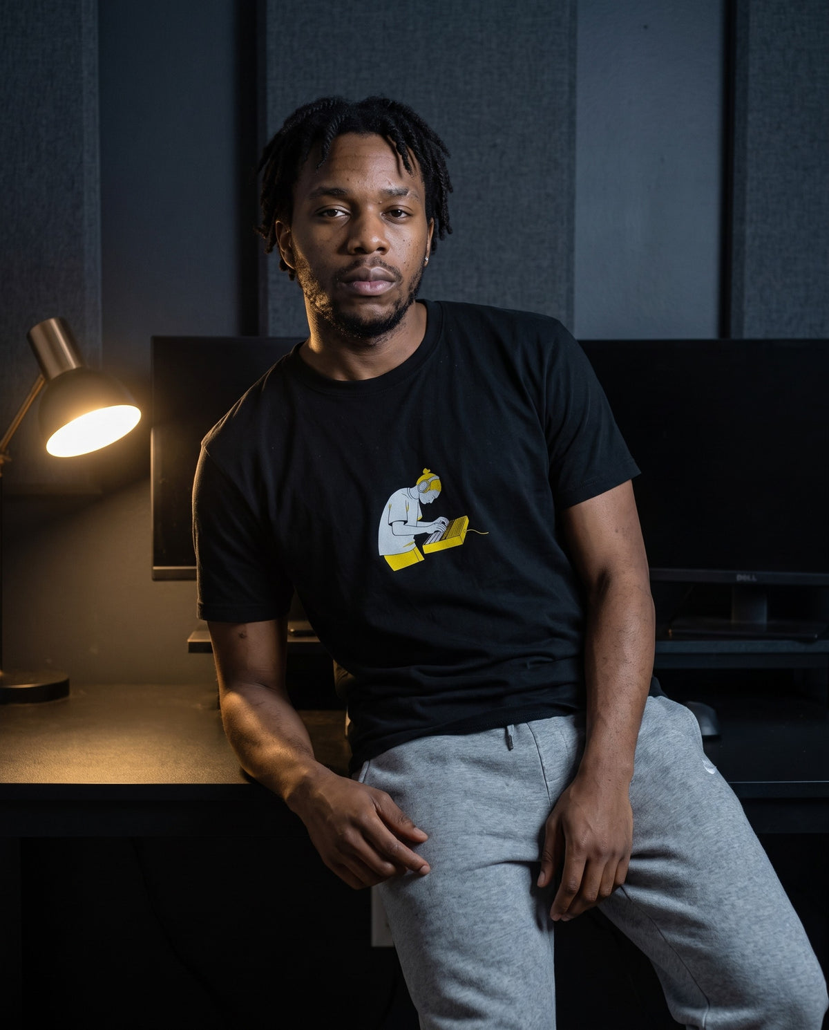 Model wearing the Pad Banger t-shirt in Black, in a home studio