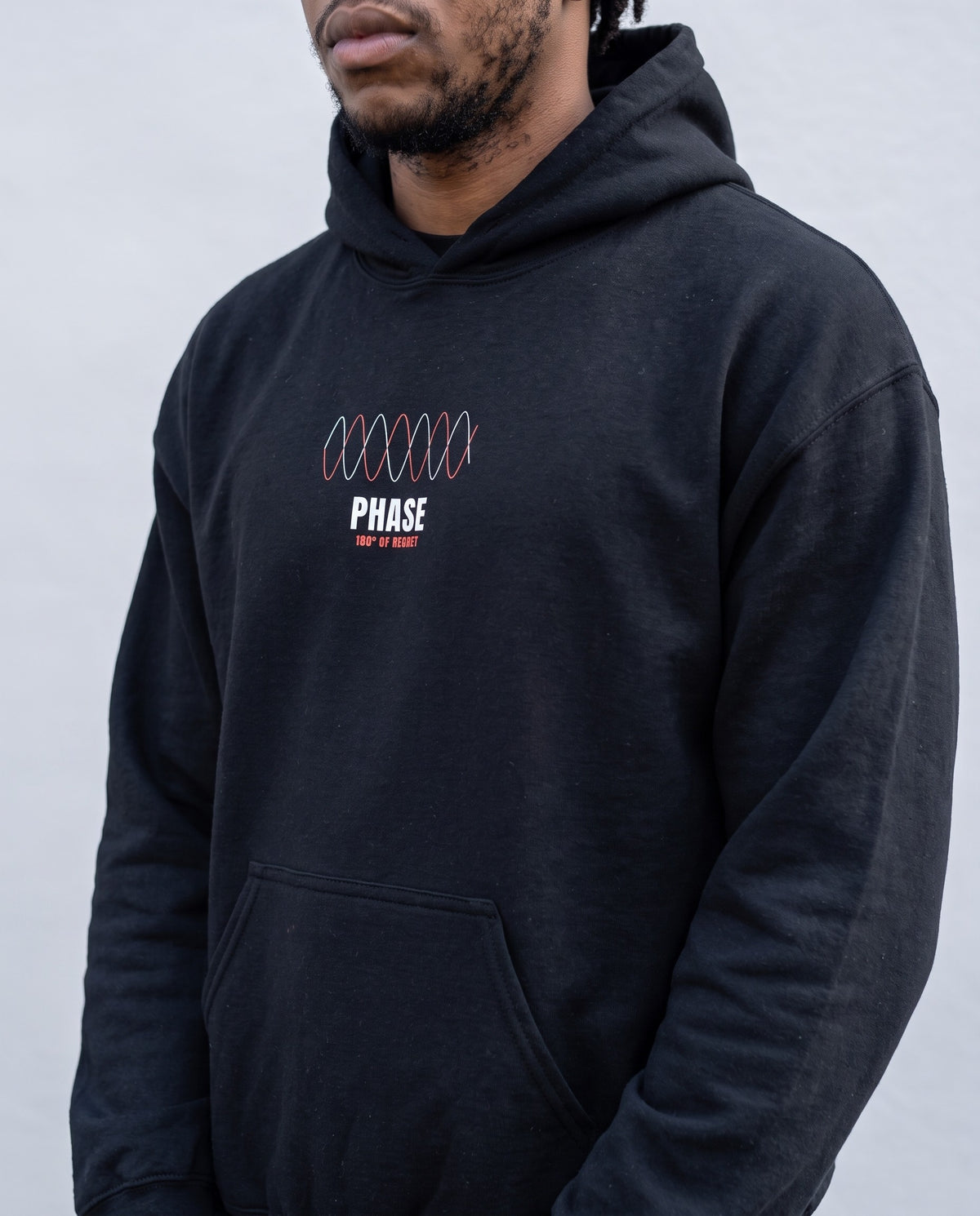 Model wearing the Phase hoodie in Black, print close-up