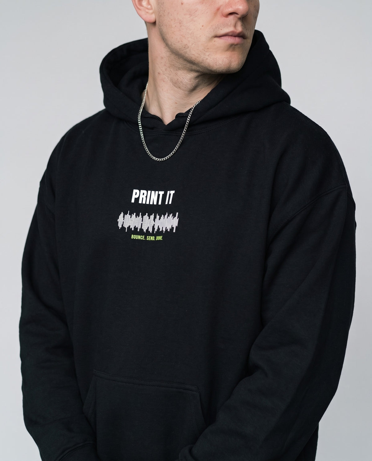 Model wearing the Print It hoodie in Black, print close-up
