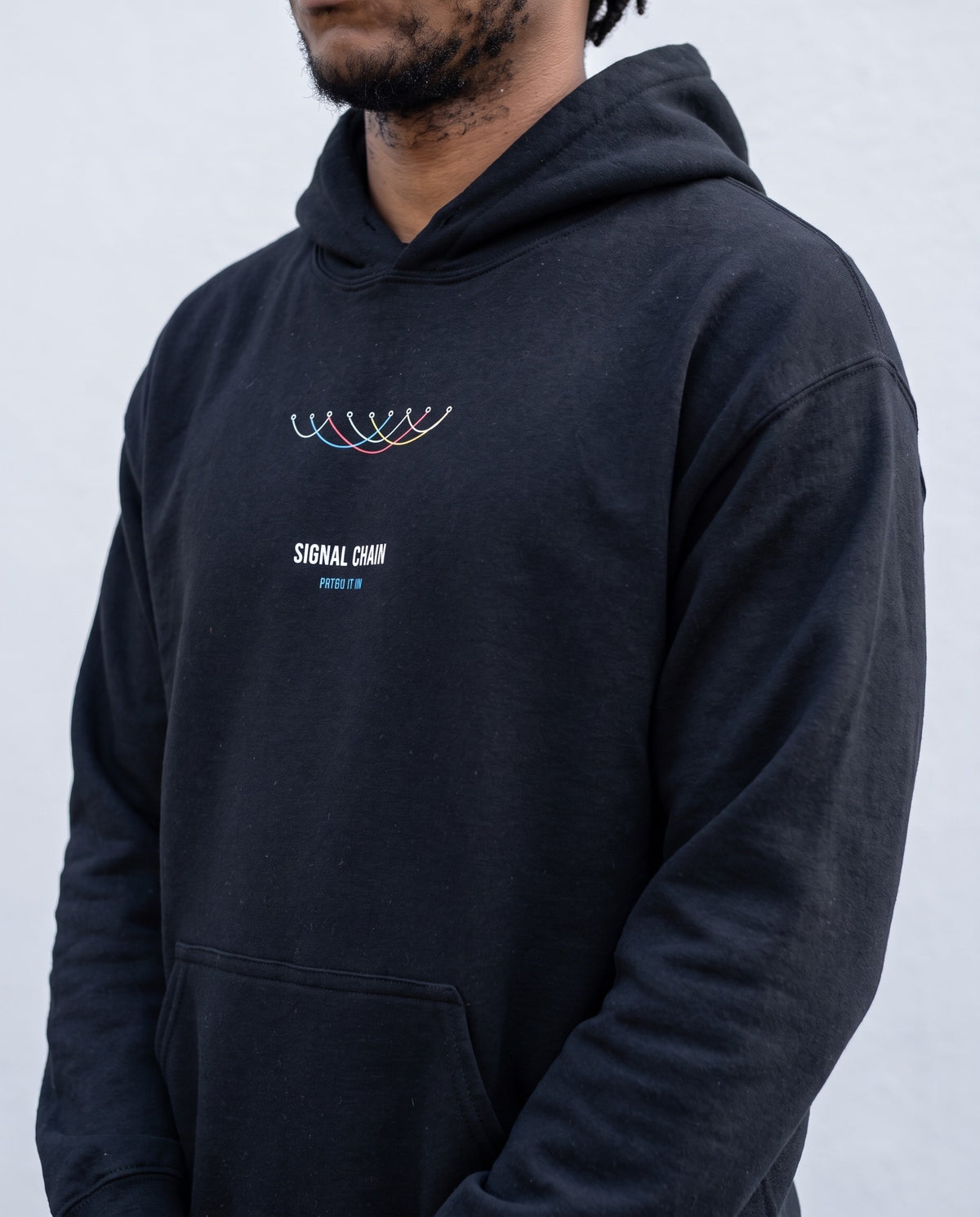 Model wearing the Signal Chain hoodie in Black, print close-up